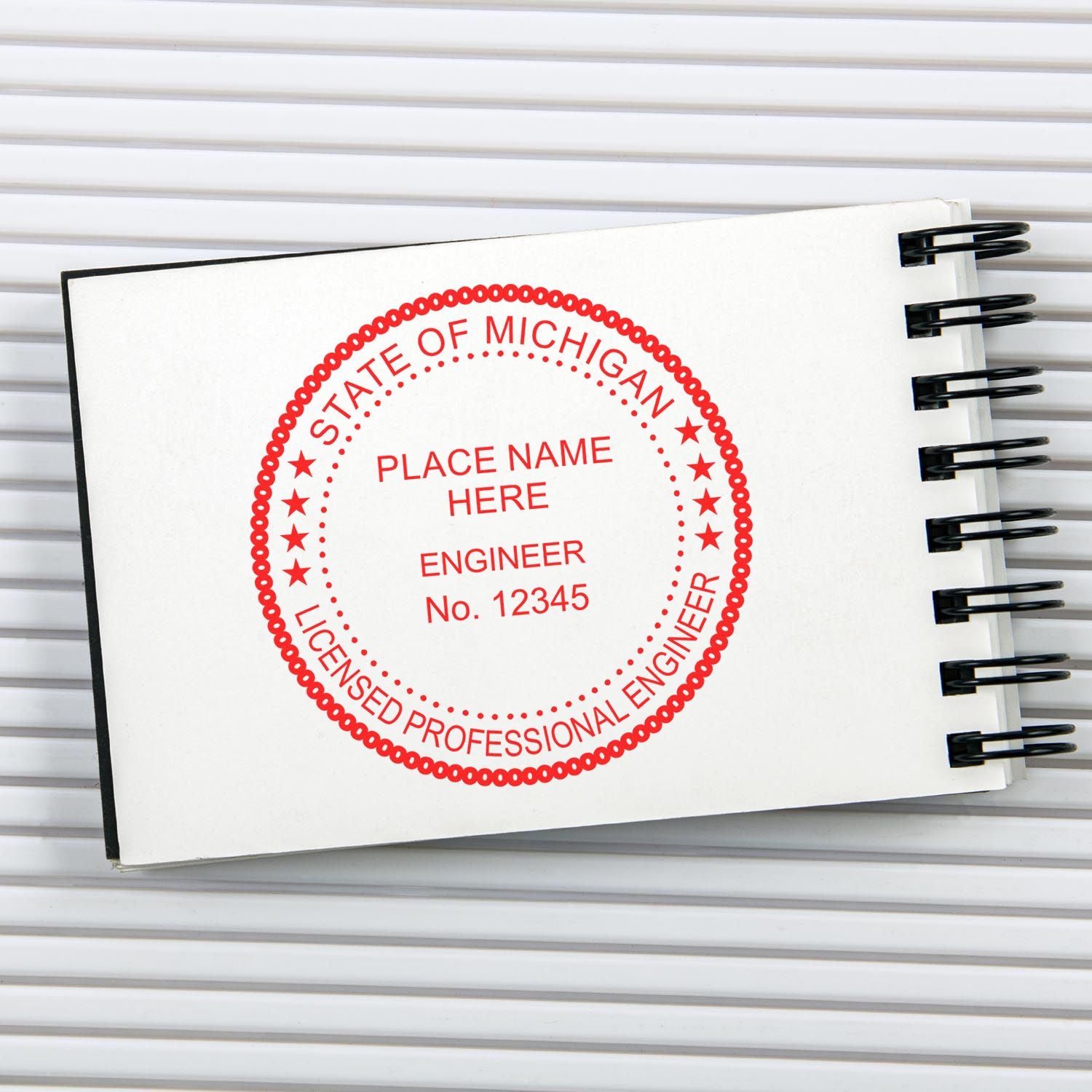 A lifestyle photo showing a stamped image of the Michigan Professional Engineer Seal Stamp on a piece of paper