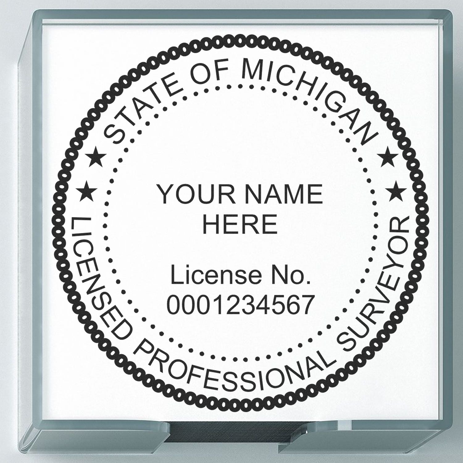 Premium MaxLight Pre-Inked Michigan Surveyors Stamp with customizable name and license number, encased in a clear holder.