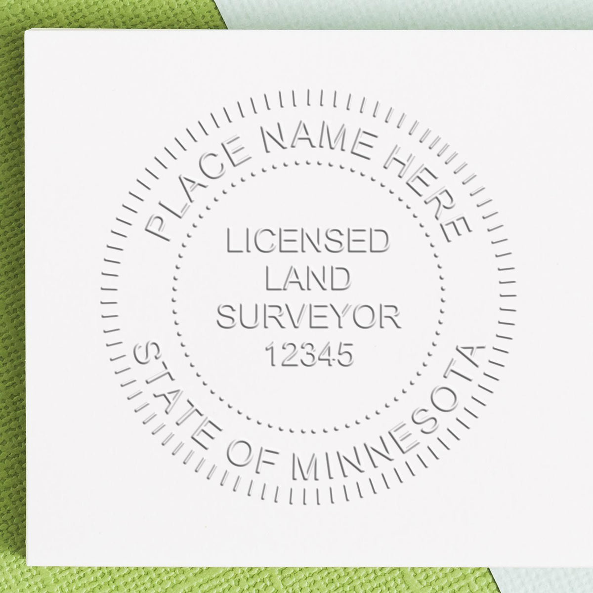 An alternative view of the Heavy Duty Cast Iron Minnesota Land Surveyor Seal Embosser stamped on a sheet of paper showing the image in use