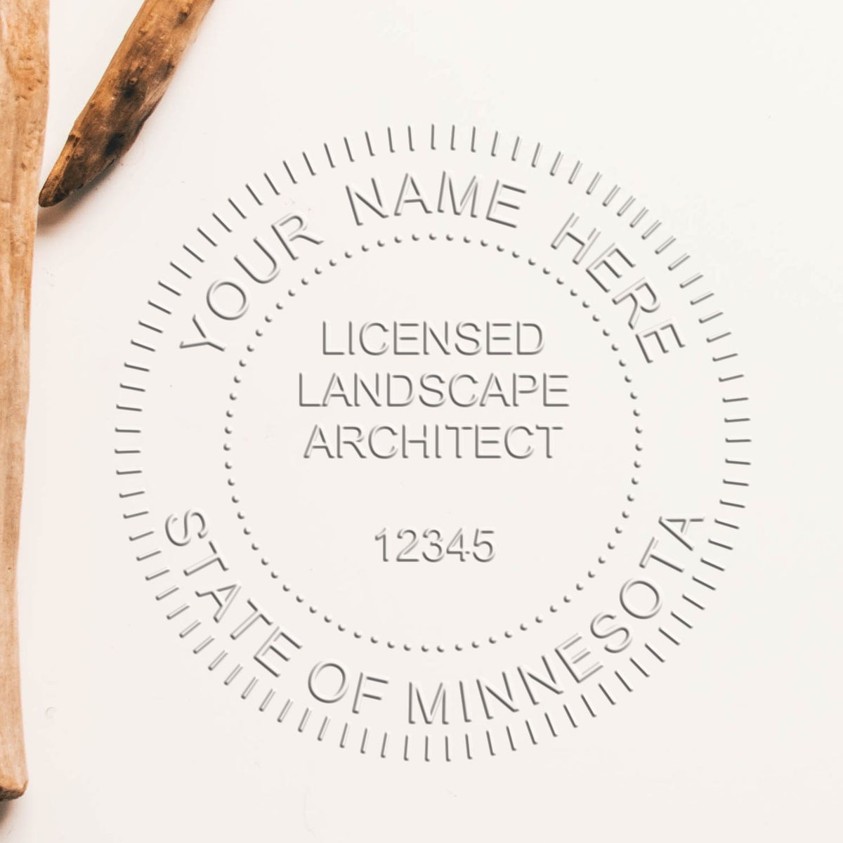 An in use photo of the Hybrid Minnesota Landscape Architect Seal showing a sample imprint on a cardstock