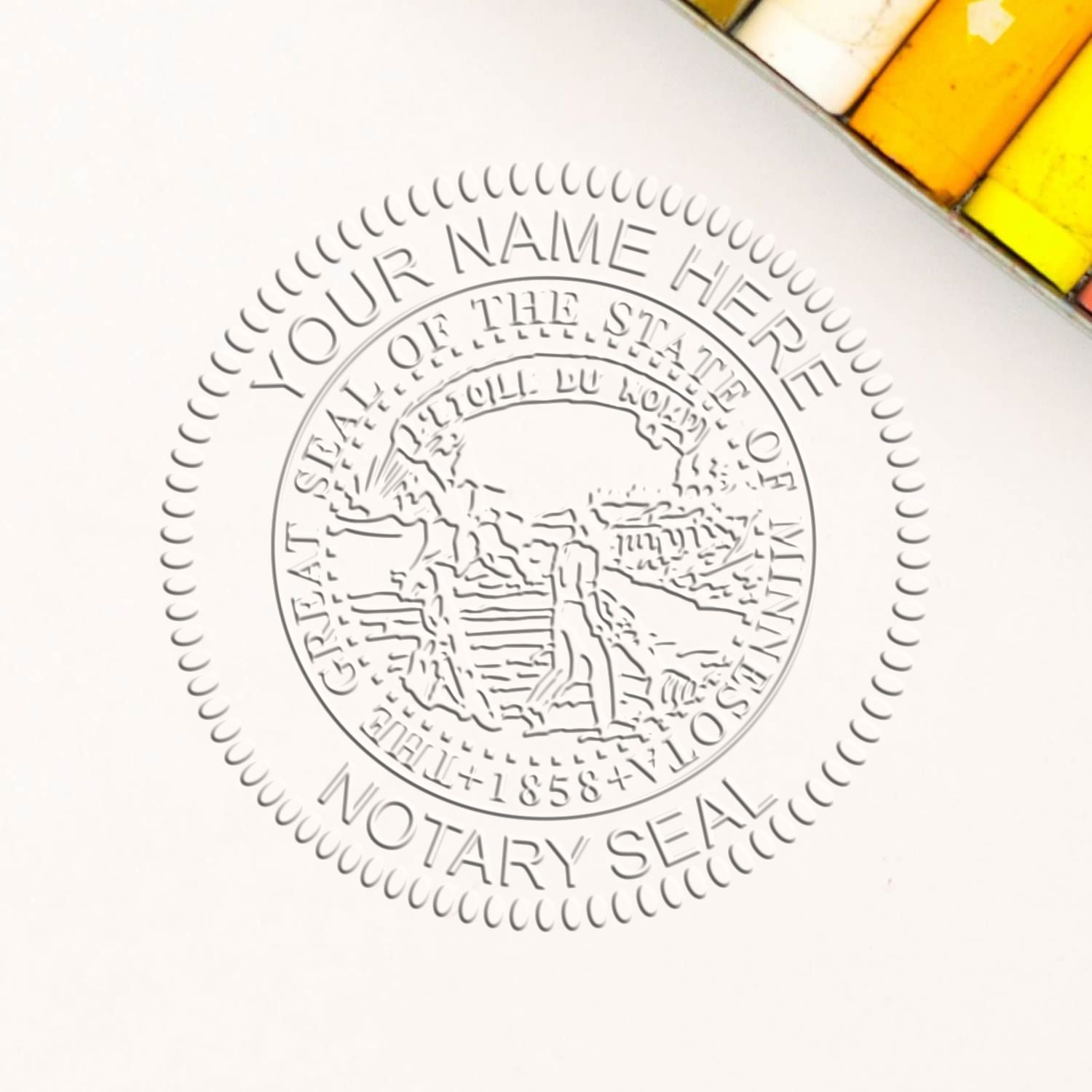 A lifestyle photo showing a stamped image of the Minnesota Handheld Notary Seal Embosser on a piece of paper