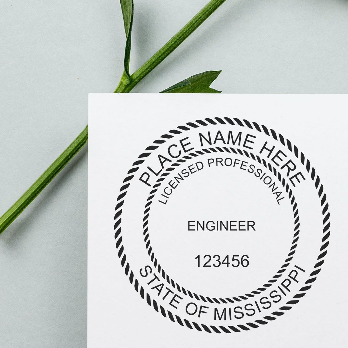 A lifestyle photo showing a stamped image of the Slim Pre-Inked Mississippi Professional Engineer Seal Stamp on a piece of paper