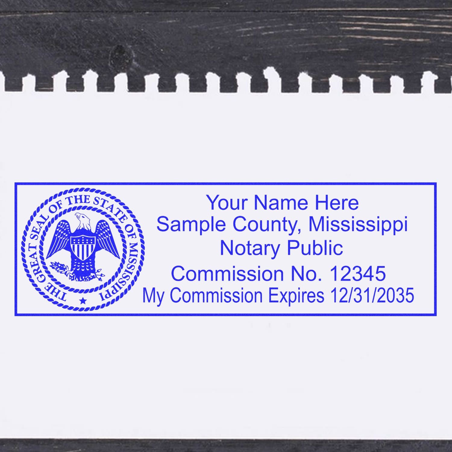 A lifestyle photo showing a stamped image of the Wooden Handle Mississippi State Seal Notary Public Stamp on a piece of paper