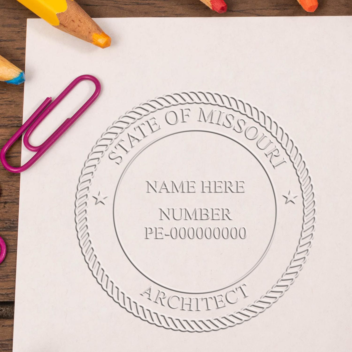 This paper is stamped with a sample imprint of the Extended Long Reach Missouri Architect Seal Embosser, signifying its quality and reliability.