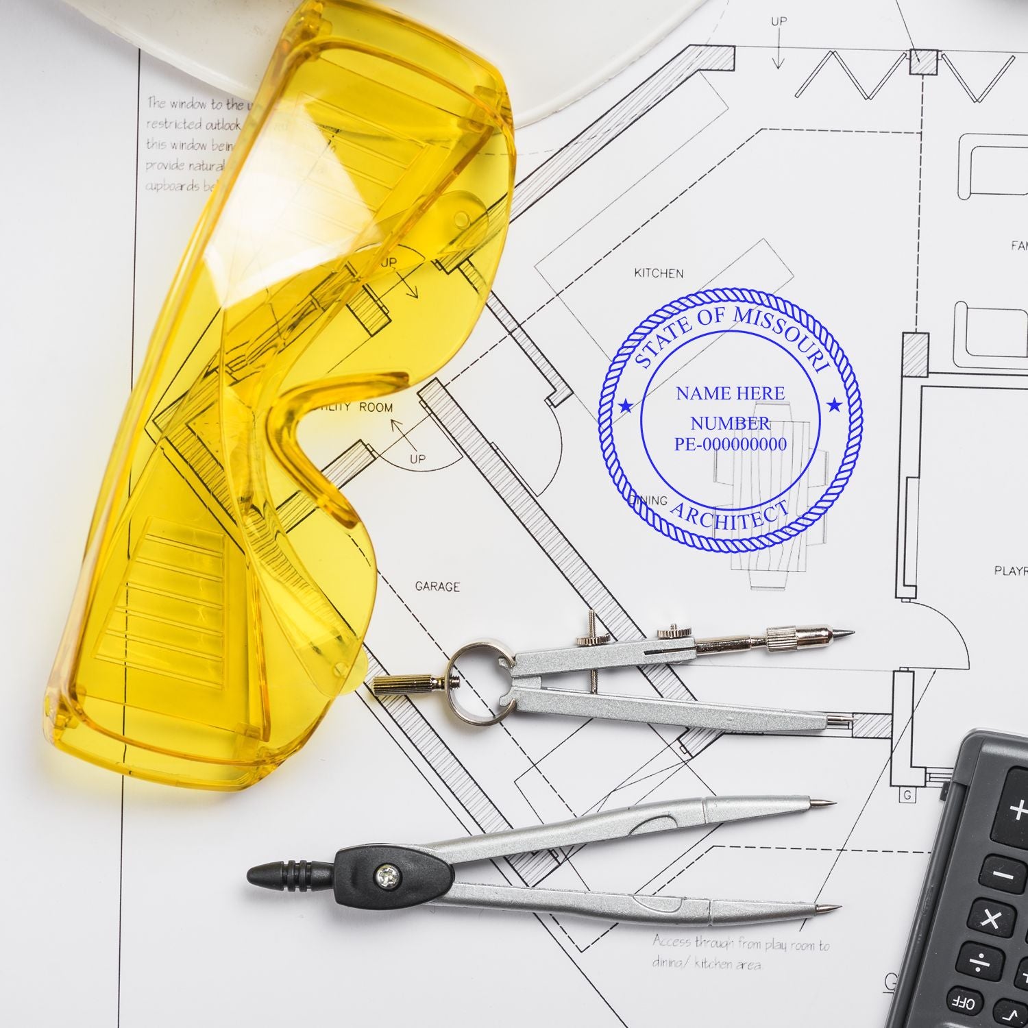 Yellow safety glasses, drafting tools, and a calculator on architectural plans stamped with the Premium MaxLight Pre-Inked Missouri Architectural Stamp.