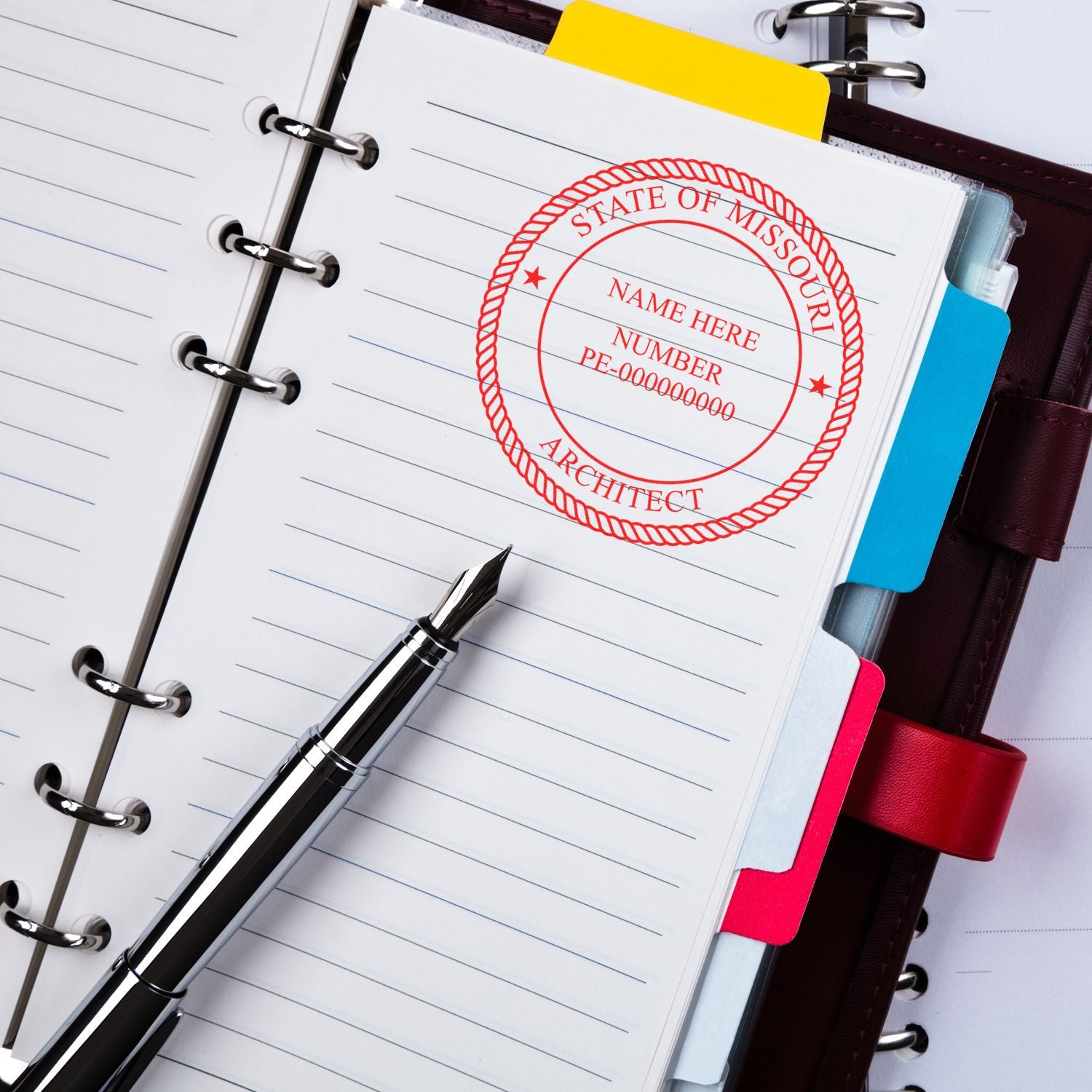 Missouri Architect Seal Stamp on a lined notebook page with a fountain pen placed beside it.