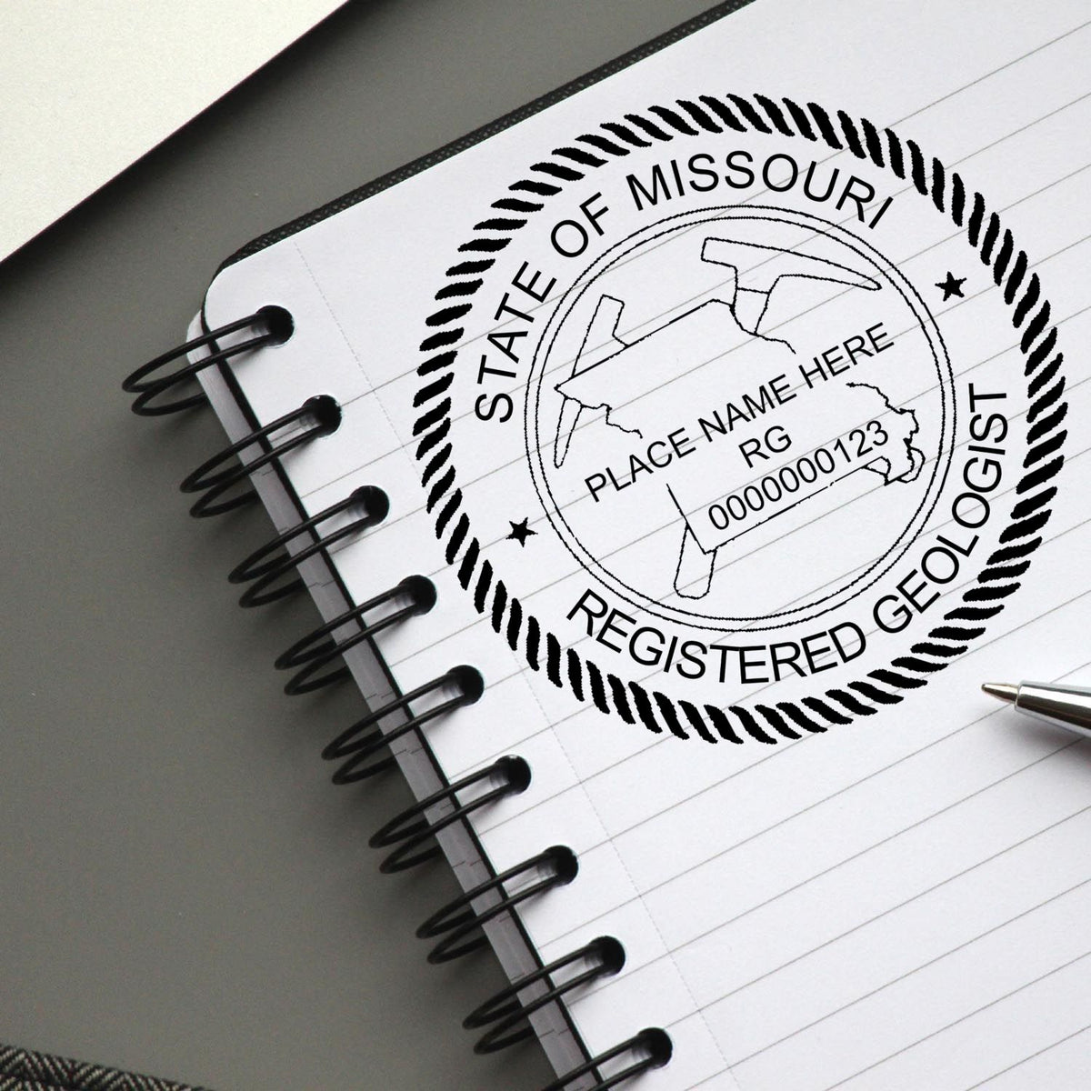 A lifestyle photo showing a stamped image of the Slim Pre-Inked Missouri Professional Geologist Seal Stamp on a piece of paper