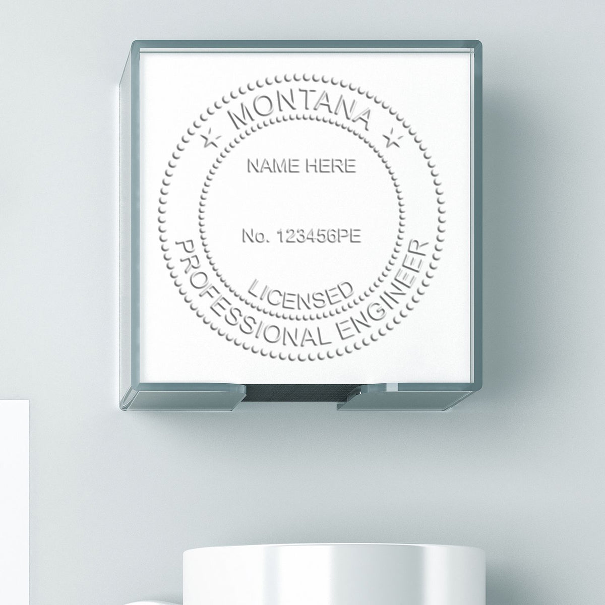 A stamped impression of the State of Montana Extended Long Reach Engineer Seal in this stylish lifestyle photo, setting the tone for a unique and personalized product.