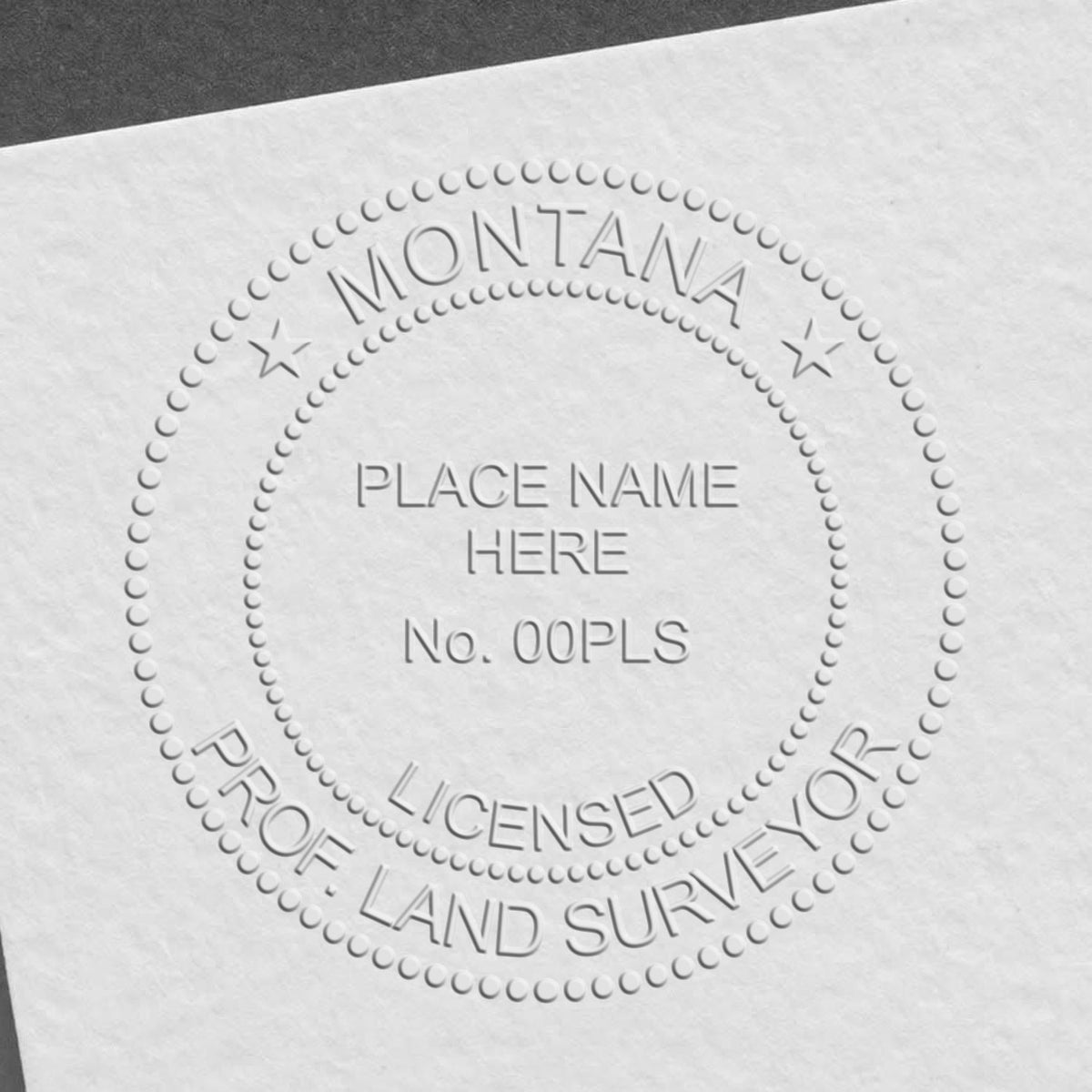 A lifestyle photo showing a stamped image of the State of Montana Soft Land Surveyor Embossing Seal on a piece of paper