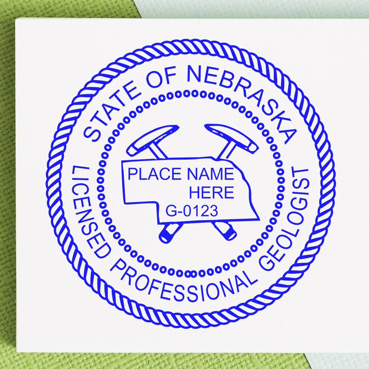 An alternative view of the Slim Pre-Inked Nebraska Professional Geologist Seal Stamp stamped on a sheet of paper showing the image in use
