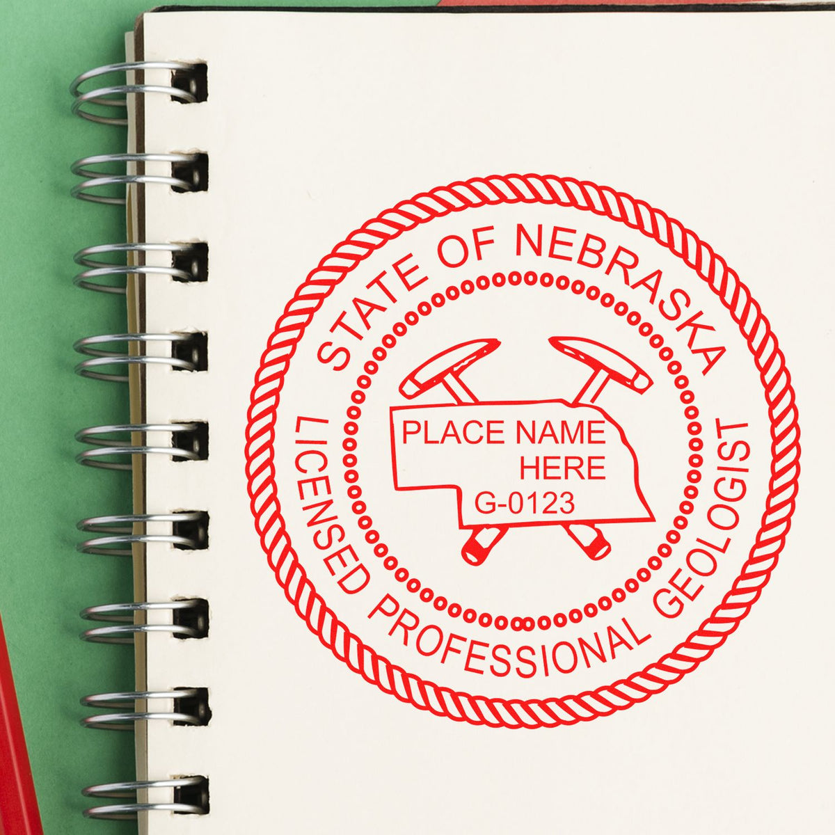 An in use photo of the Slim Pre-Inked Nebraska Professional Geologist Seal Stamp showing a sample imprint on a cardstock