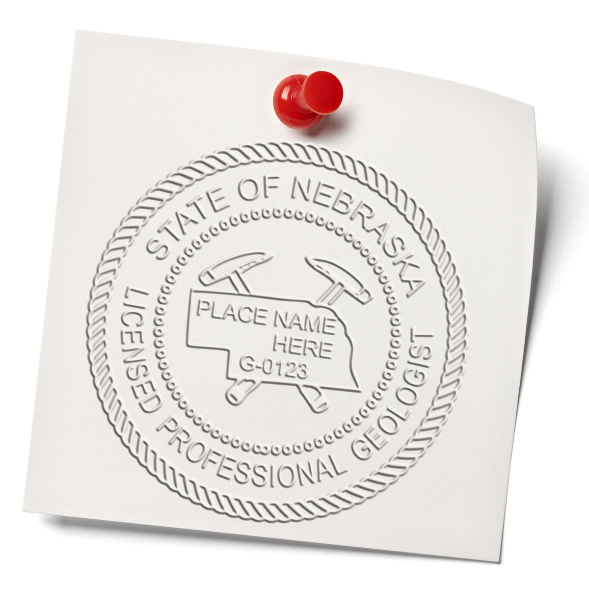 A lifestyle photo showing a stamped image of the Heavy Duty Cast Iron Nebraska Geologist Seal Embosser on a piece of paper