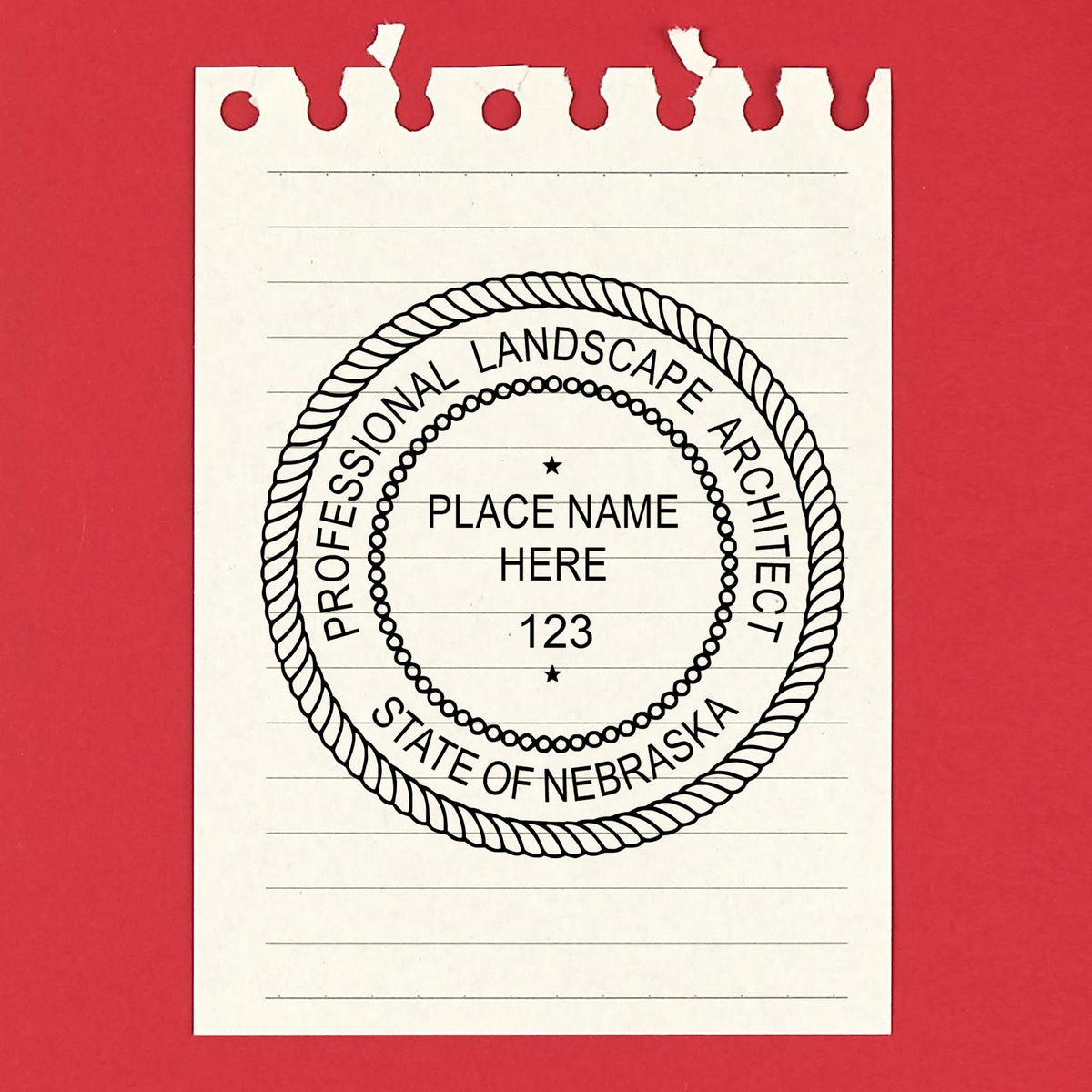 A lifestyle photo showing a stamped image of the Nebraska Landscape Architectural Seal Stamp on a piece of paper