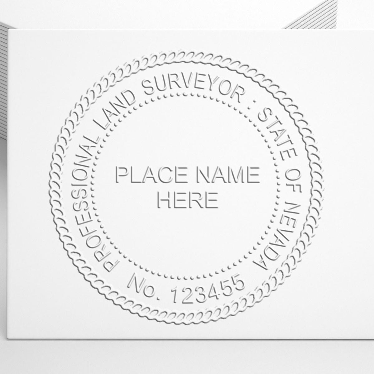 A lifestyle photo showing a stamped image of the Handheld Nevada Land Surveyor Seal on a piece of paper