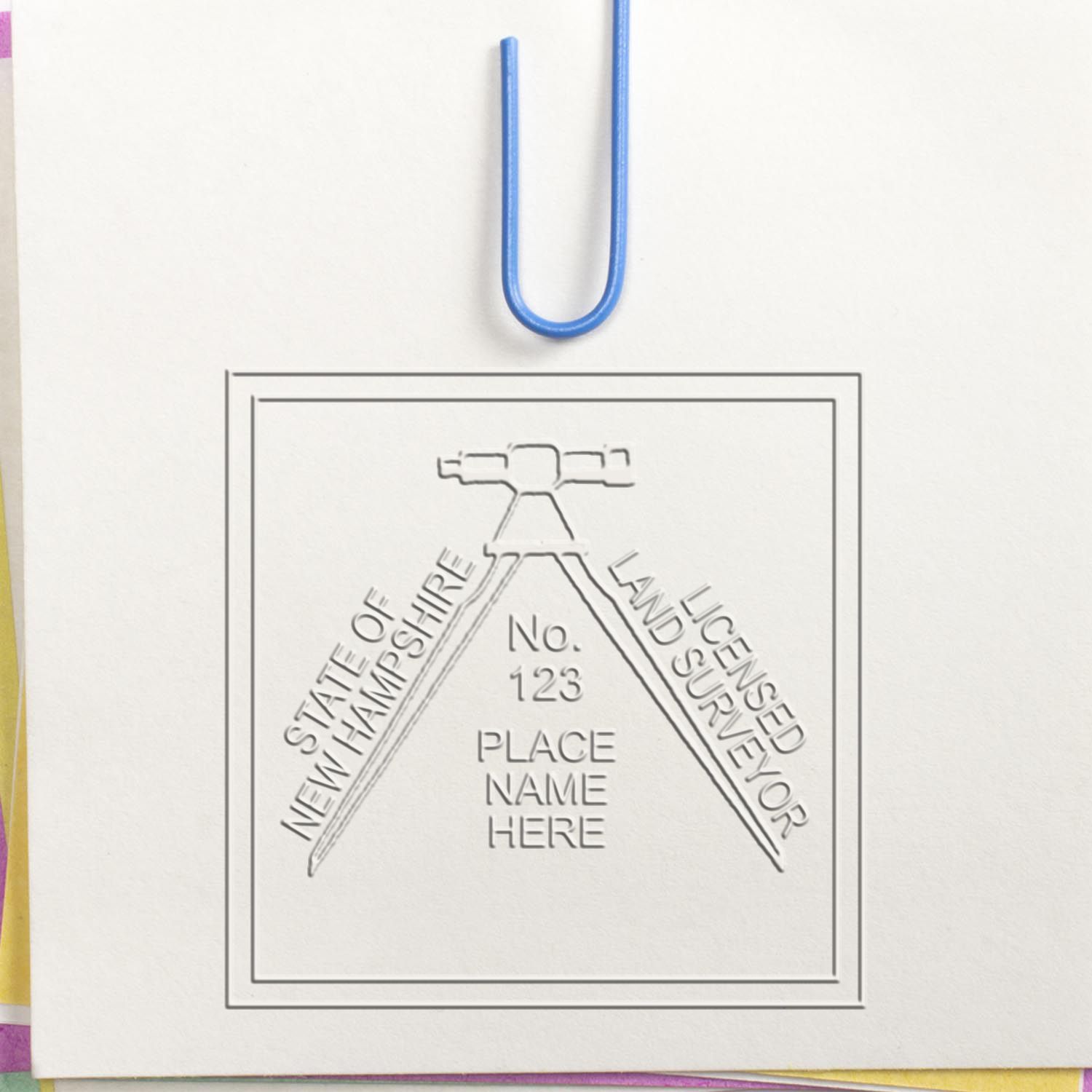 Another Example of a stamped impression of the Heavy Duty Cast Iron New Hampshire Land Surveyor Seal Embosser on a piece of office paper.