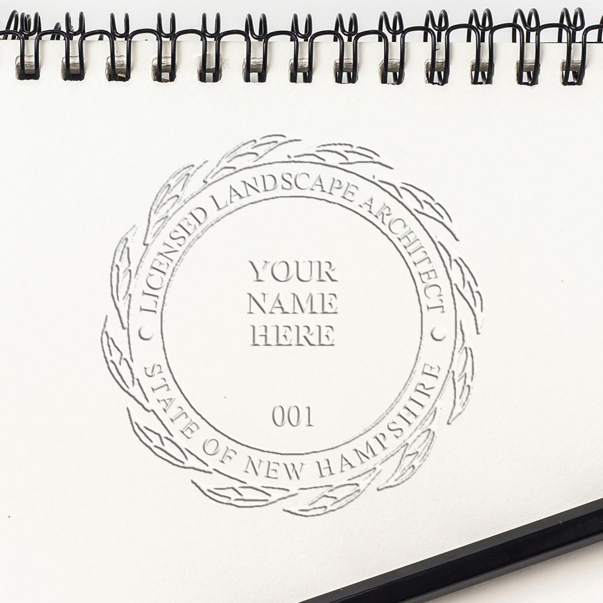 A photograph of the Hybrid New Hampshire Landscape Architect Seal stamp impression reveals a vivid, professional image of the on paper.