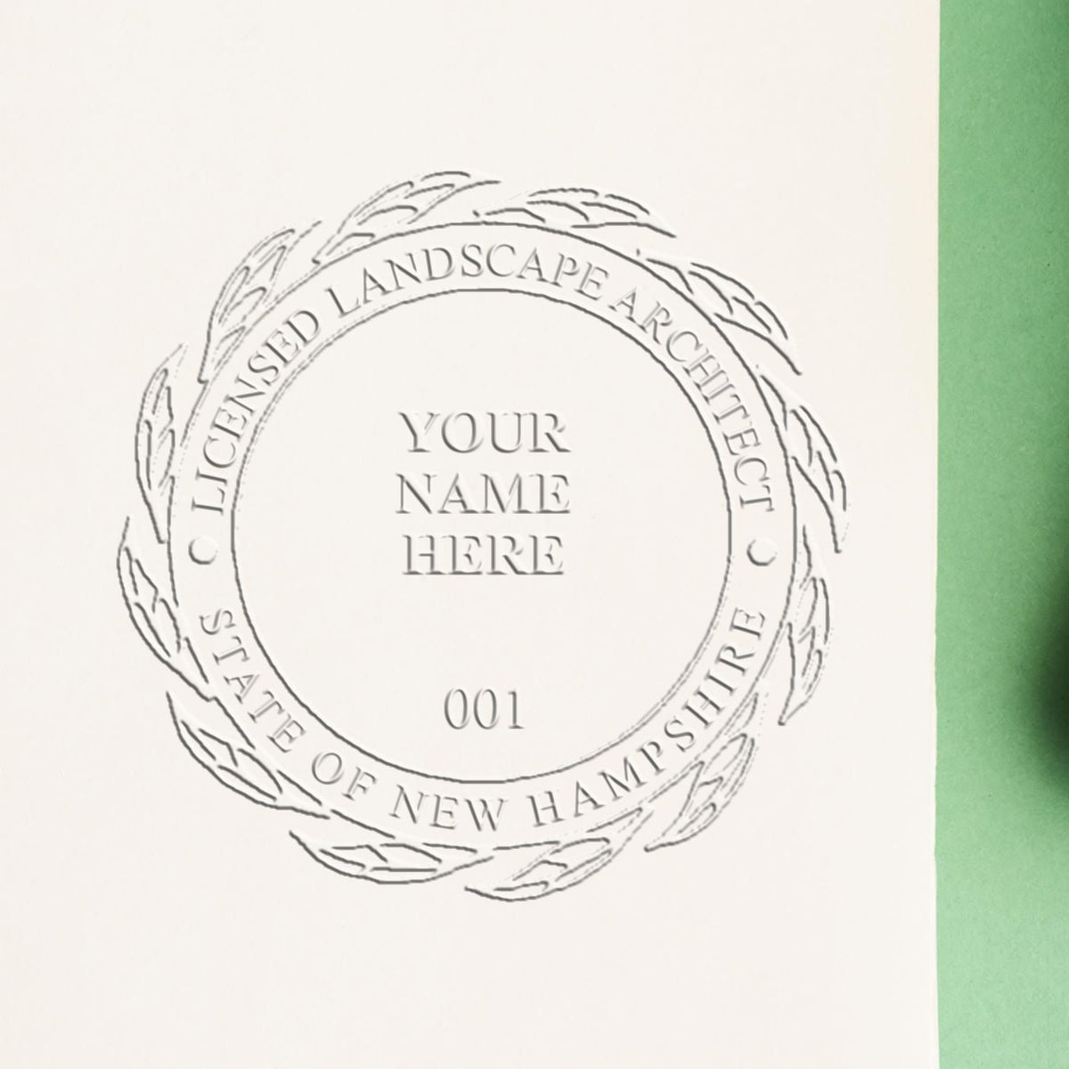 An in use photo of the Hybrid New Hampshire Landscape Architect Seal showing a sample imprint on a cardstock