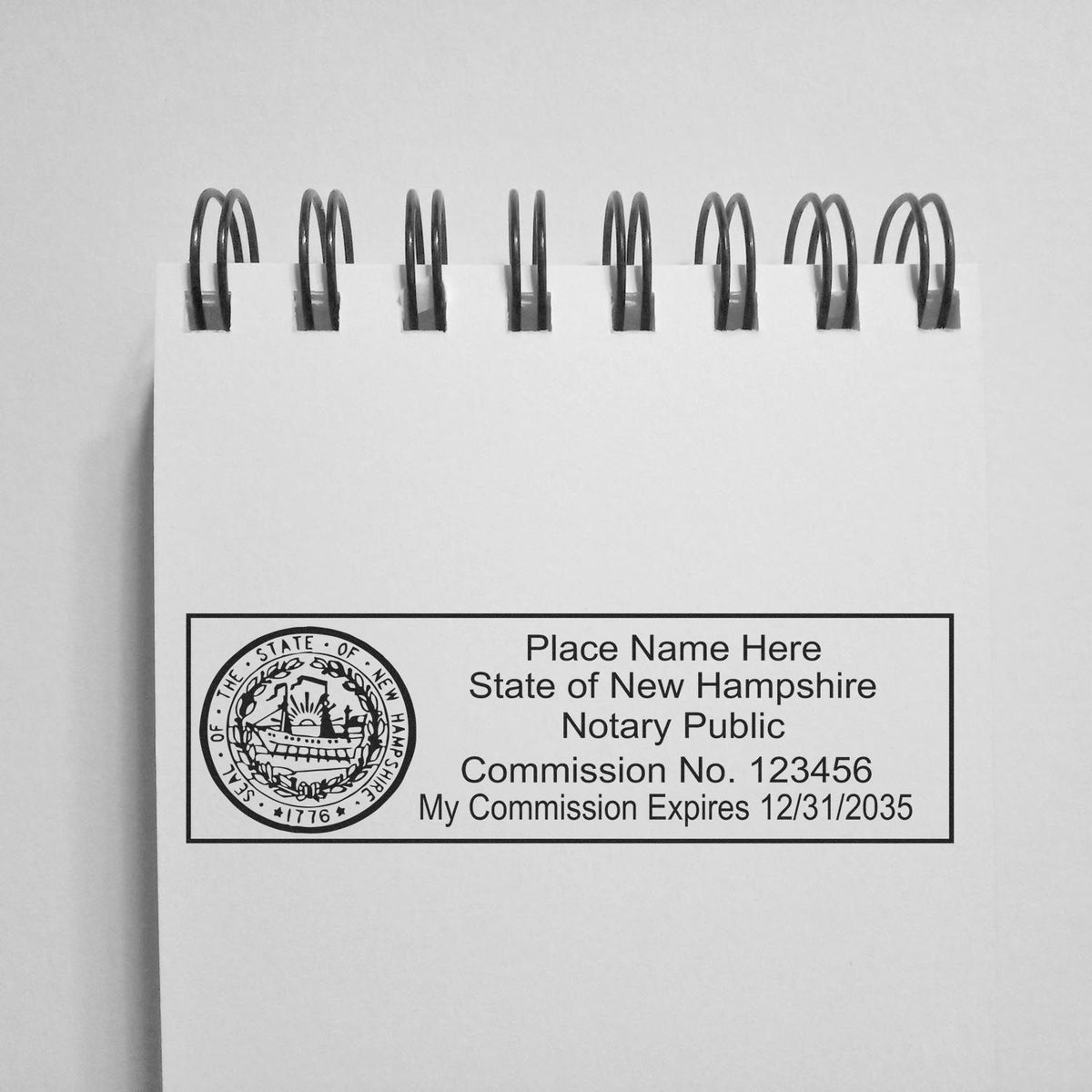 A photograph of the Wooden Handle New Hampshire State Seal Notary Public Stamp stamp impression reveals a vivid, professional image of the on paper.