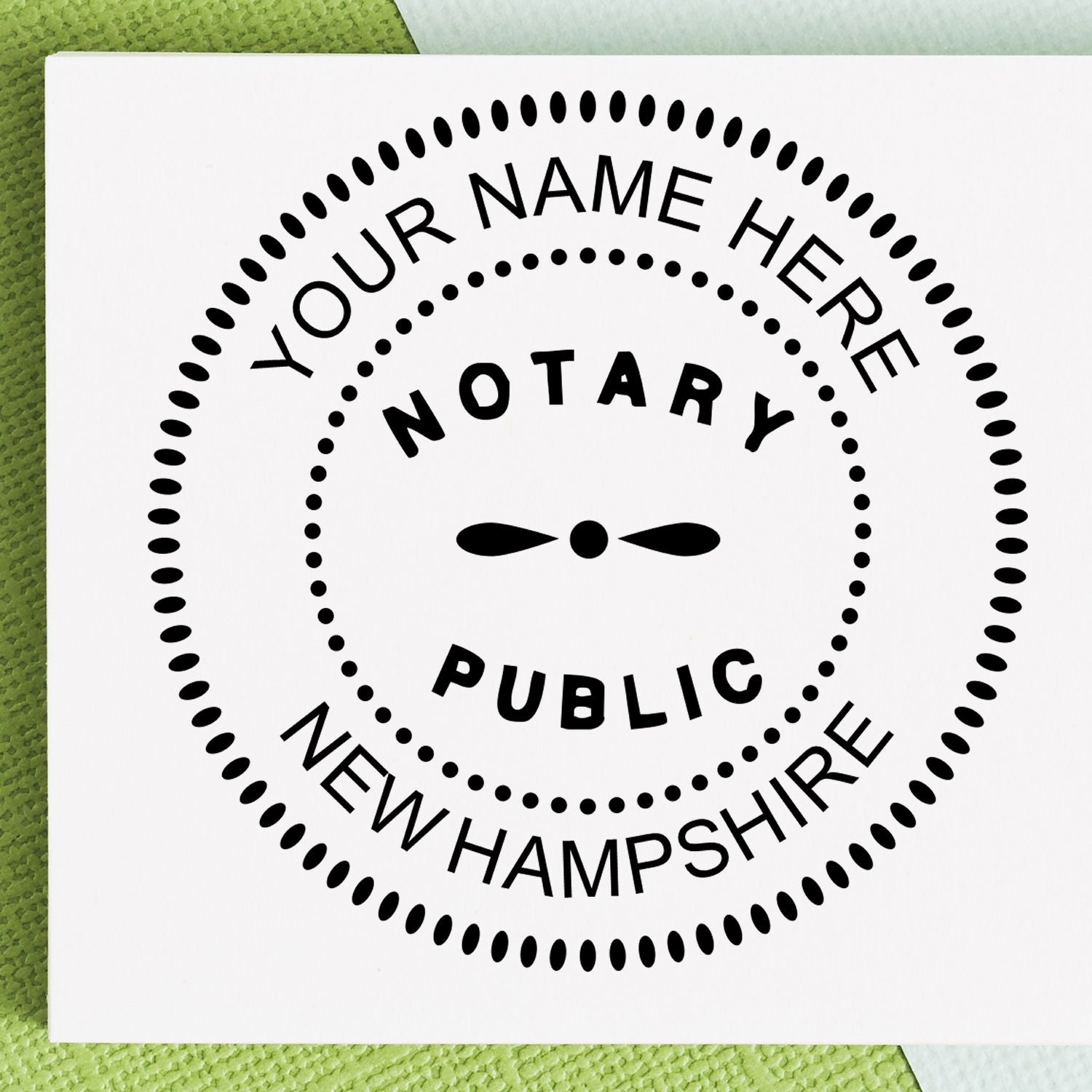 A lifestyle photo showing a stamped image of the Round New Hampshire Notary Public Seal Stamp on a piece of paper