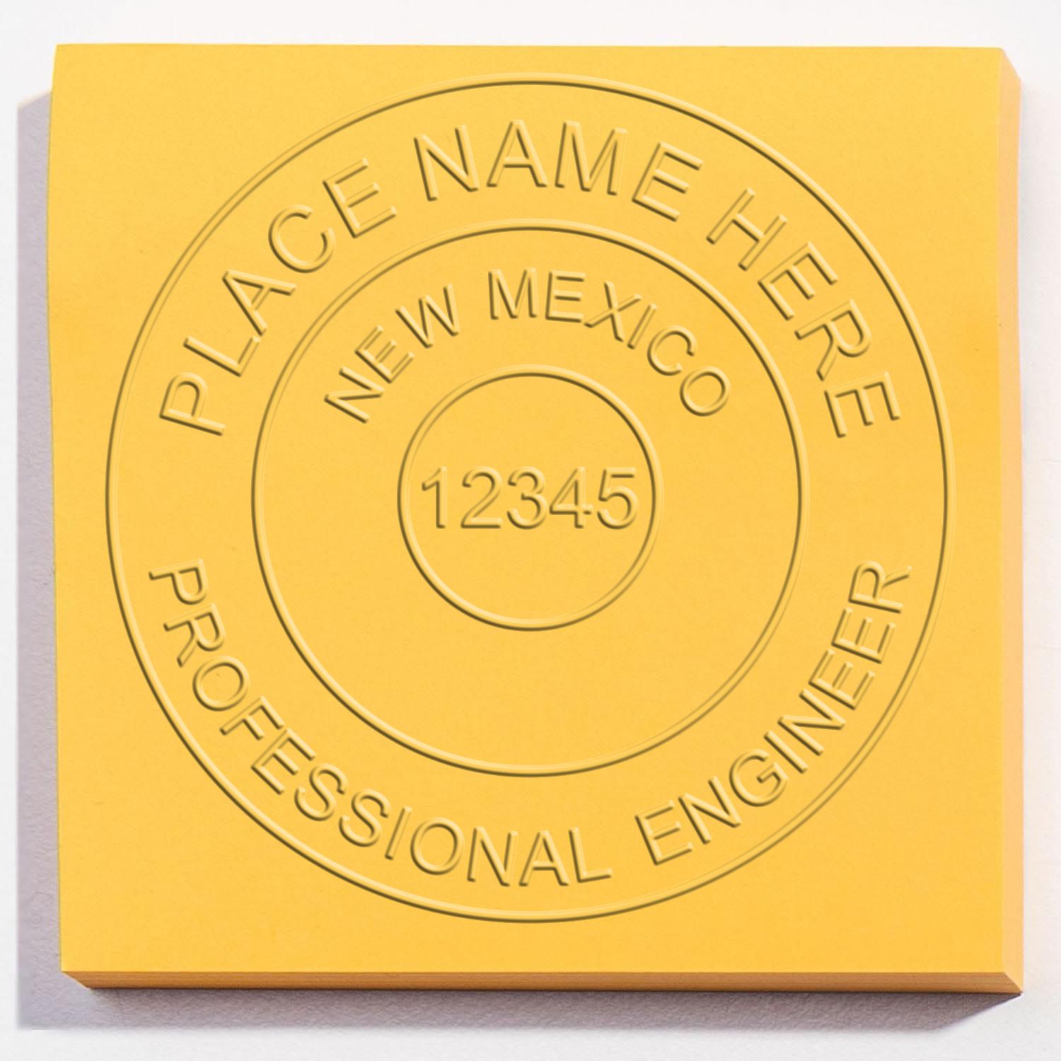 An in use photo of the Hybrid New Mexico Engineer Seal showing a sample imprint on a cardstock