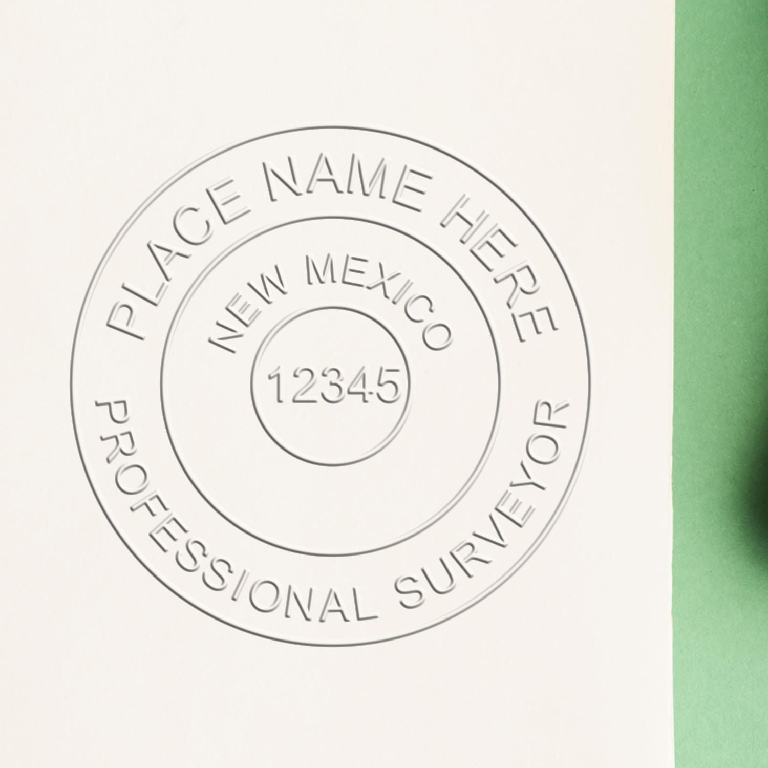 A lifestyle photo showing a stamped image of the New Mexico Desk Surveyor Seal Embosser on a piece of paper
