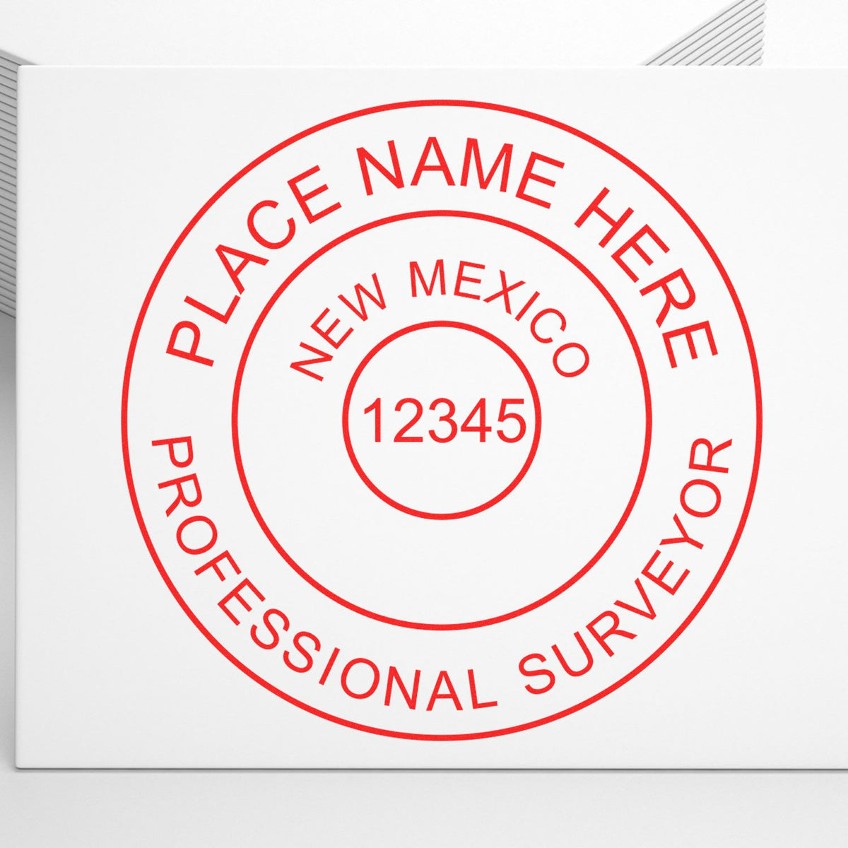 A lifestyle photo showing a stamped image of the Slim Pre-Inked New Mexico Land Surveyor Seal Stamp on a piece of paper