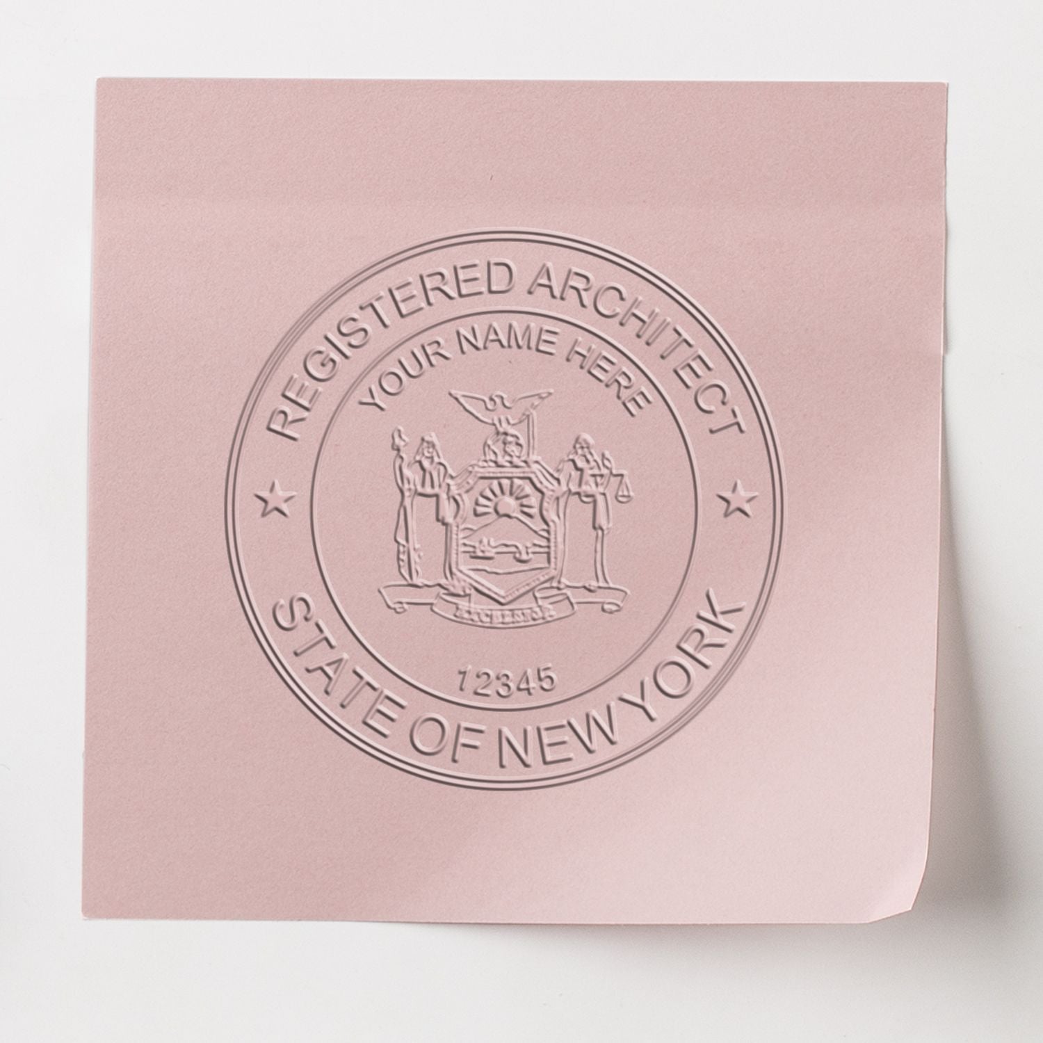 An in use photo of the Gift New York Architect Seal showing a sample imprint on a cardstock