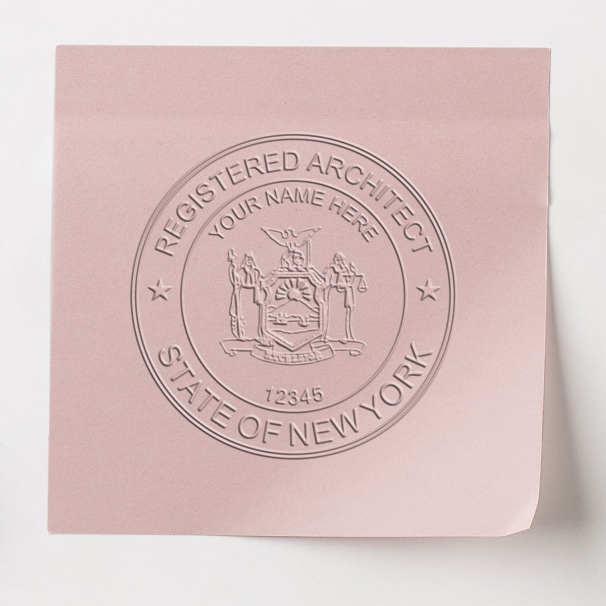 An in use photo of the Gift New York Architect Seal showing a sample imprint on a cardstock
