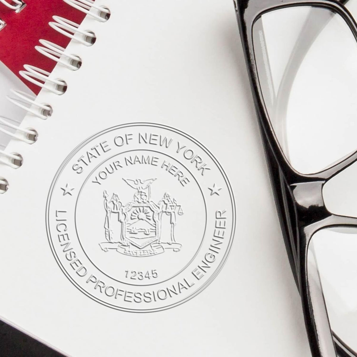 An in use photo of the Hybrid New York Engineer Seal showing a sample imprint on a cardstock