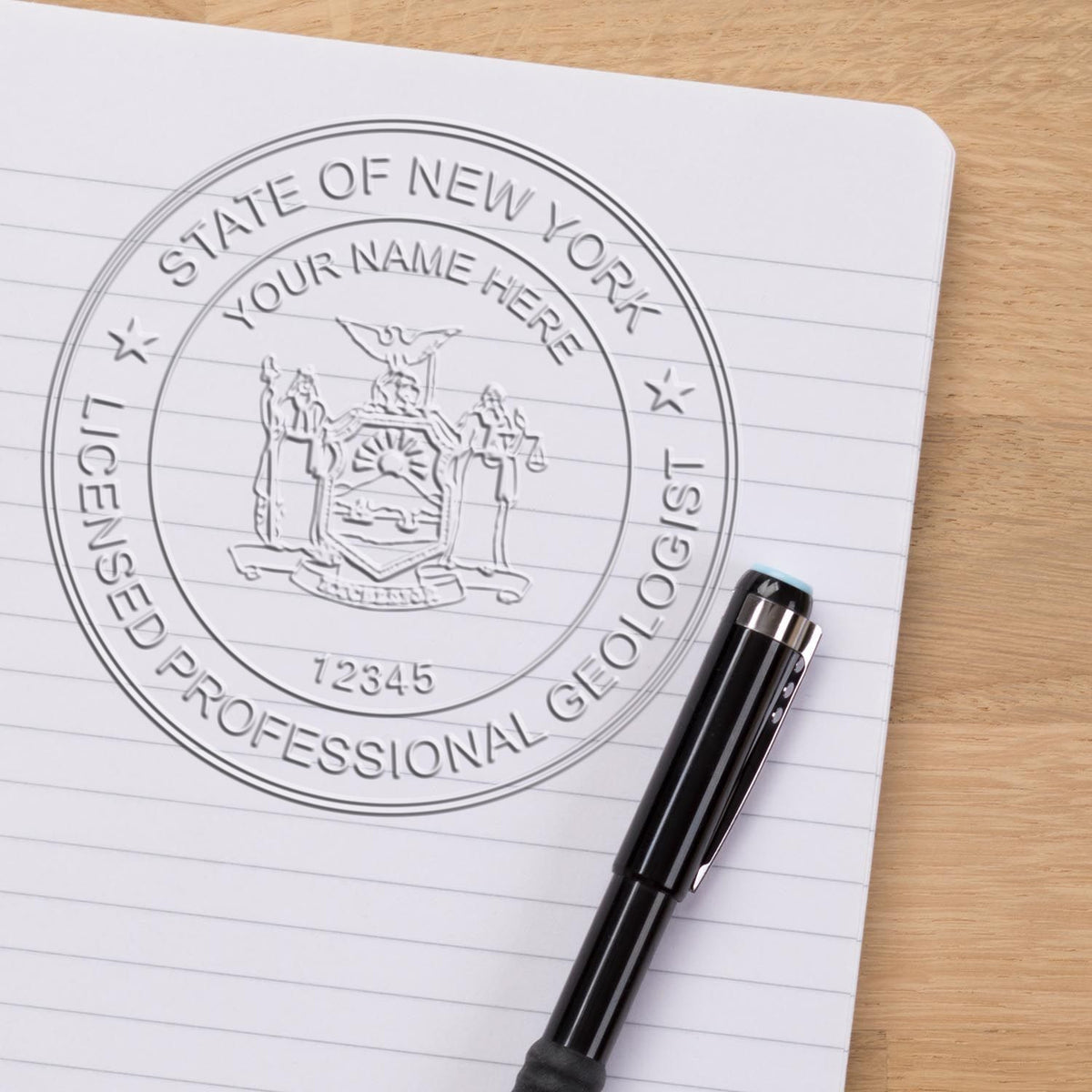 An in use photo of the Hybrid New York Geologist Seal showing a sample imprint on a cardstock