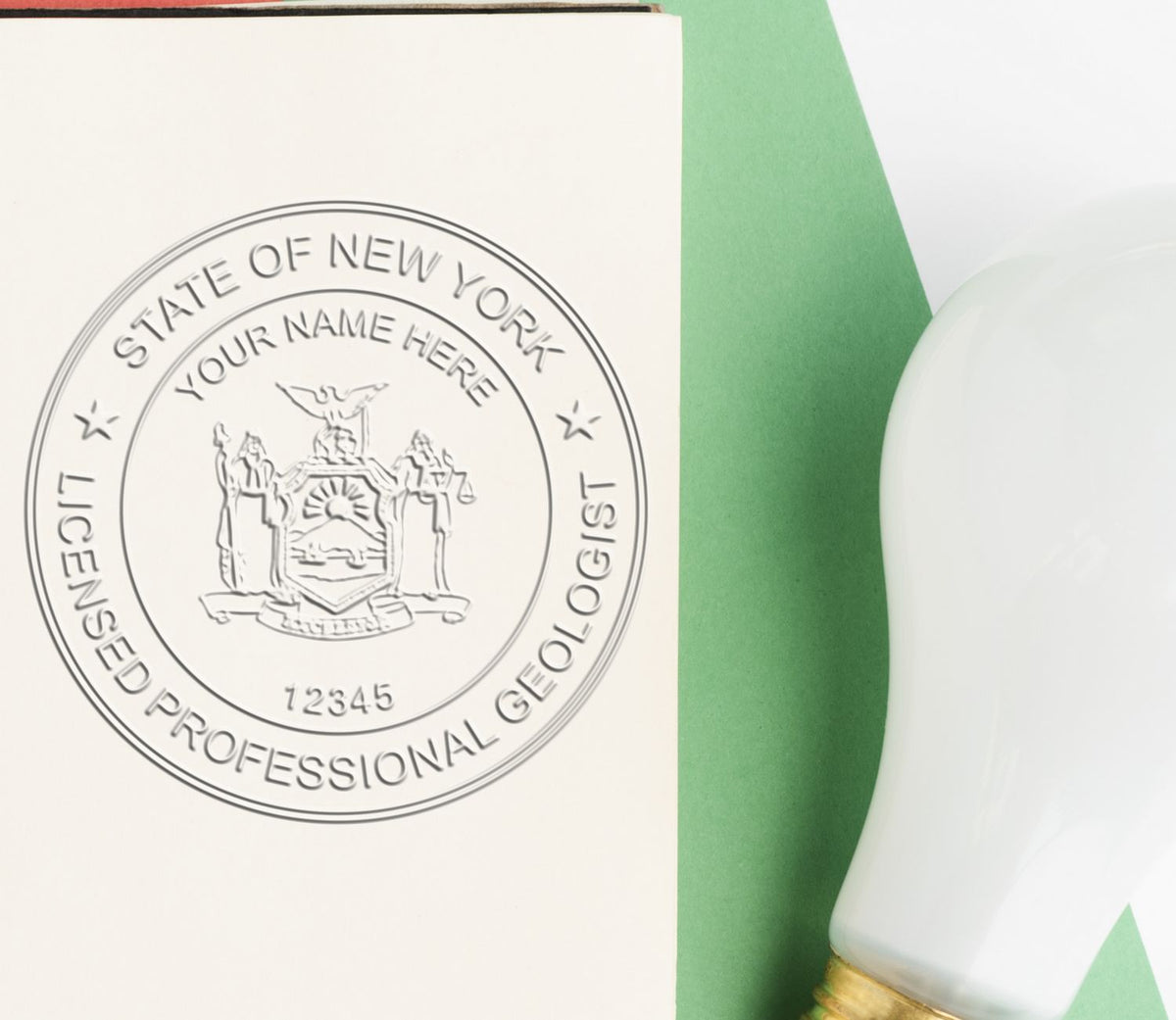 An in use photo of the Long Reach New York Geology Seal showing a sample imprint on a cardstock