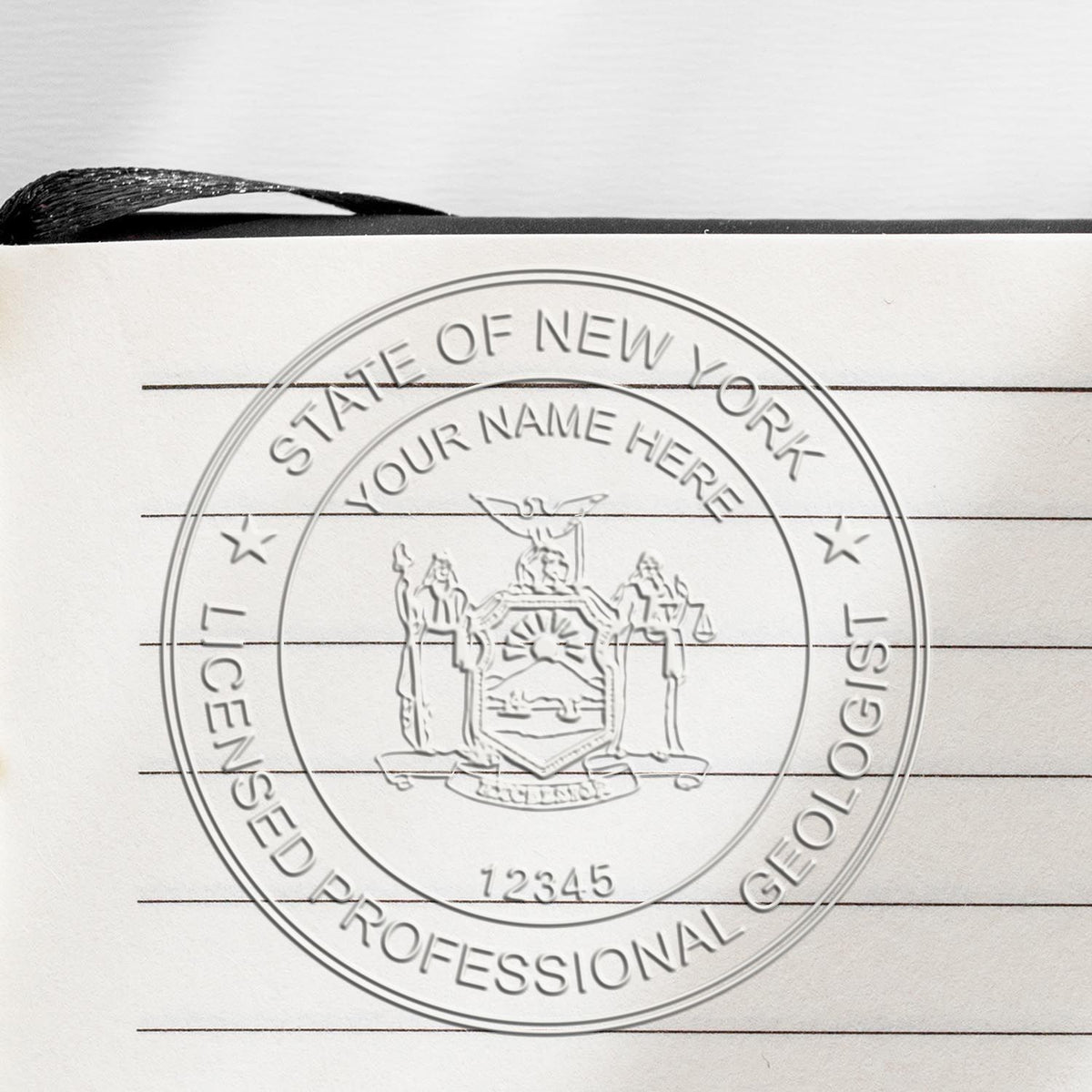 A lifestyle photo showing a stamped image of the Handheld New York Professional Geologist Embosser on a piece of paper