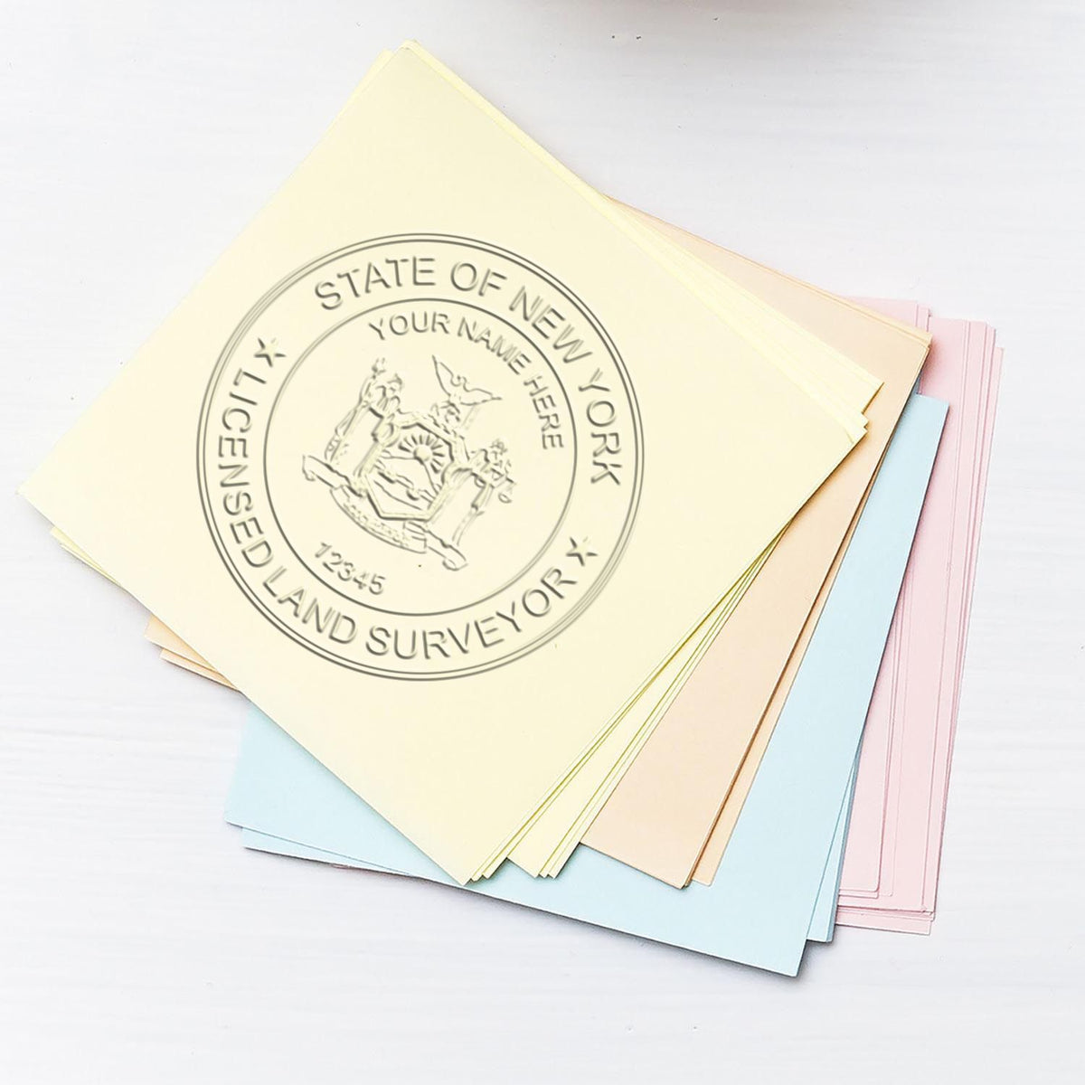 An in use photo of the Gift New York Land Surveyor Seal showing a sample imprint on a cardstock