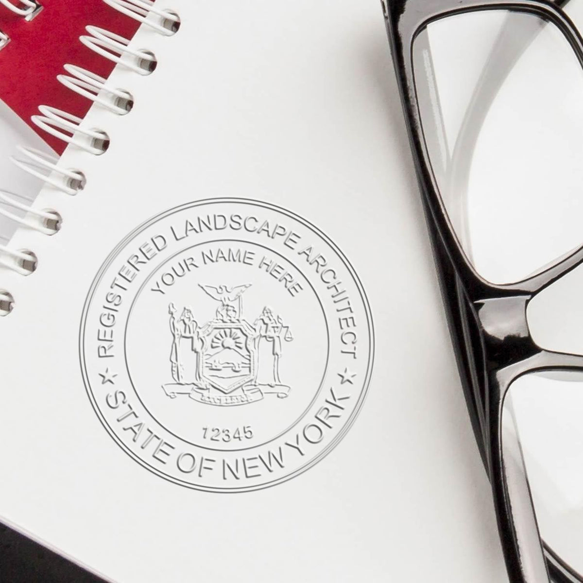 An in use photo of the Hybrid New York Landscape Architect Seal showing a sample imprint on a cardstock