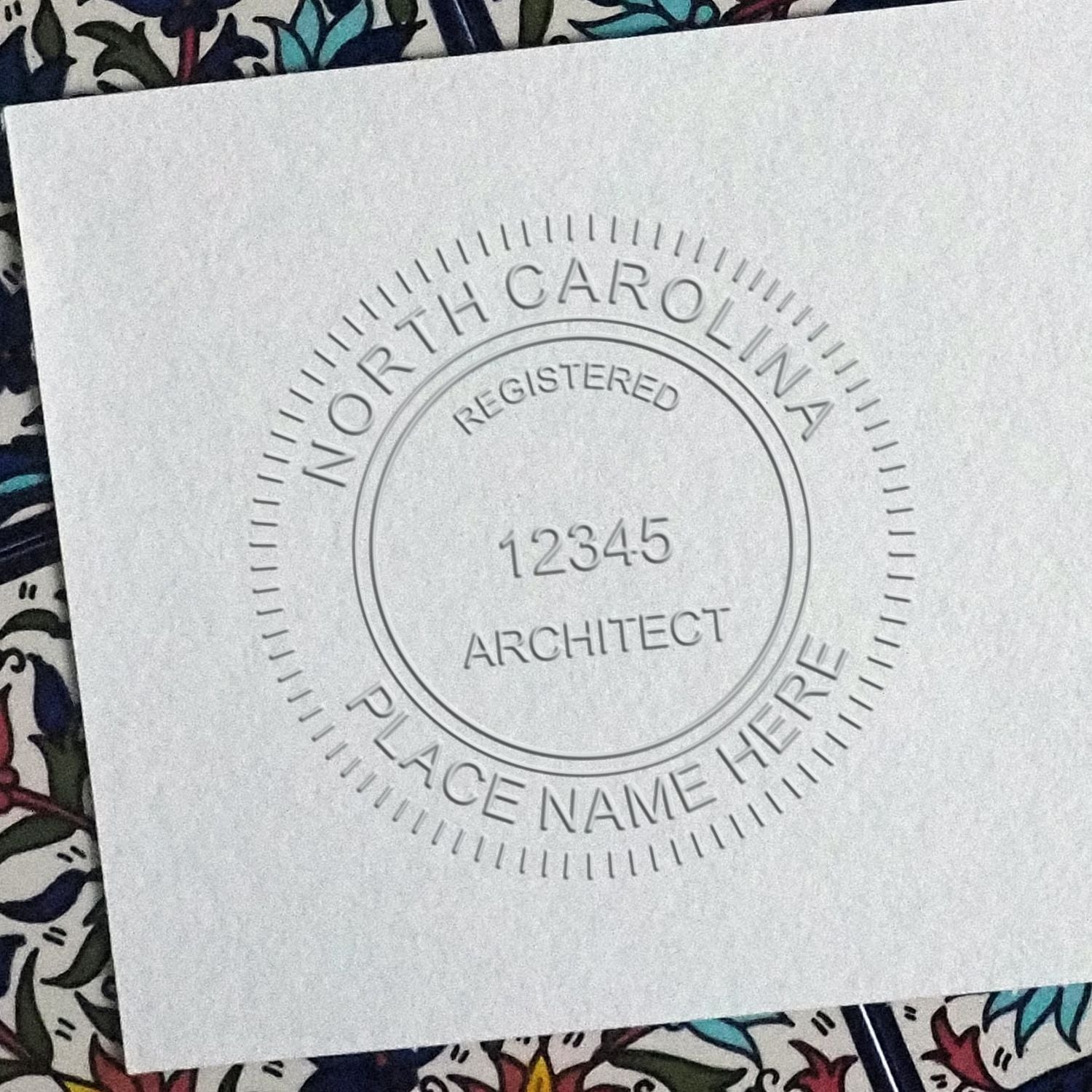 A photograph of the Hybrid North Carolina Architect Seal stamp impression reveals a vivid, professional image of the on paper.