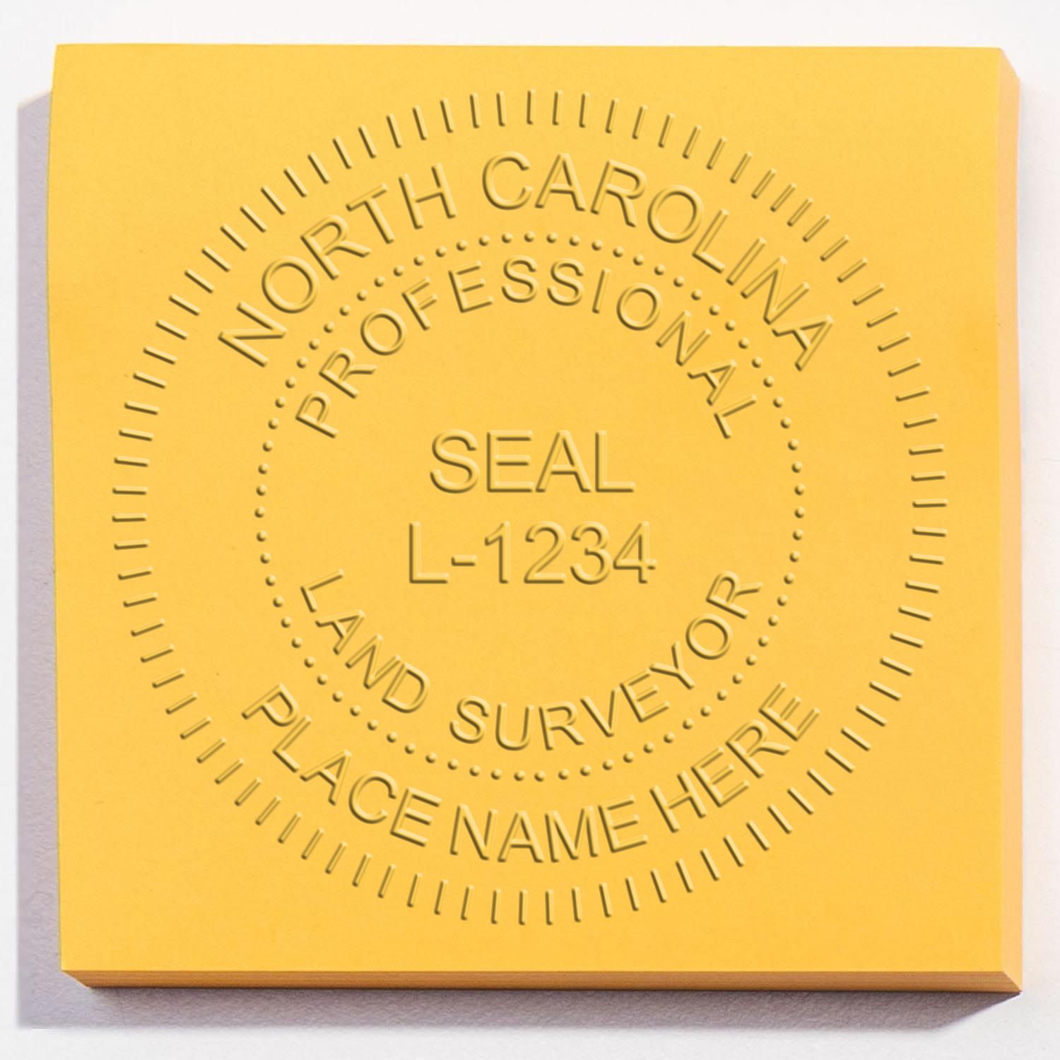 A lifestyle photo showing a stamped image of the Handheld North Carolina Land Surveyor Seal on a piece of paper