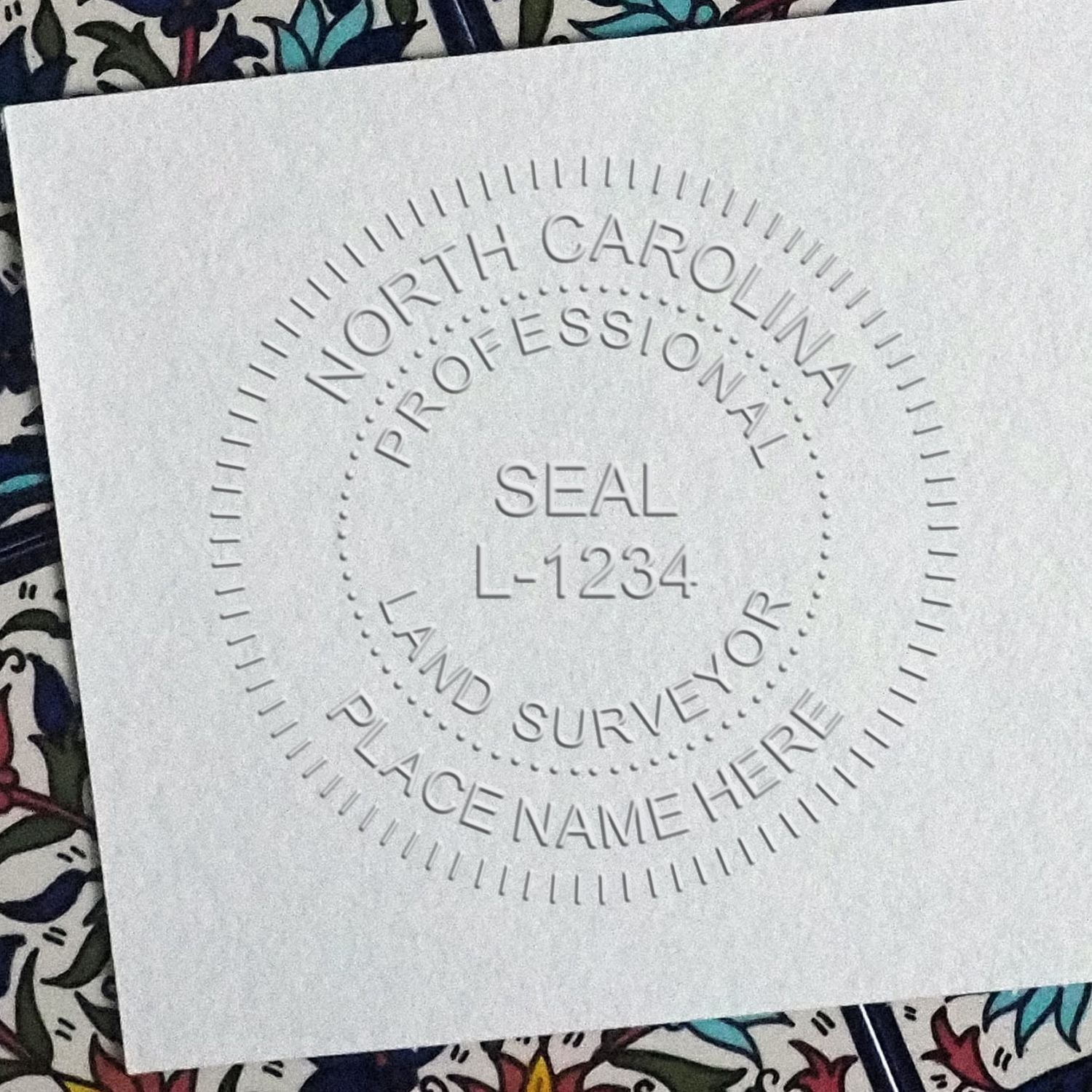 A stamped impression of the North Carolina Desk Surveyor Seal Embosser in this stylish lifestyle photo, setting the tone for a unique and personalized product.