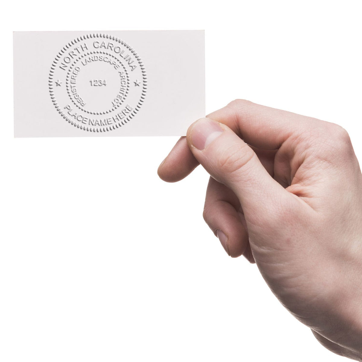 An in use photo of the Gift North Carolina Landscape Architect Seal showing a sample imprint on a cardstock