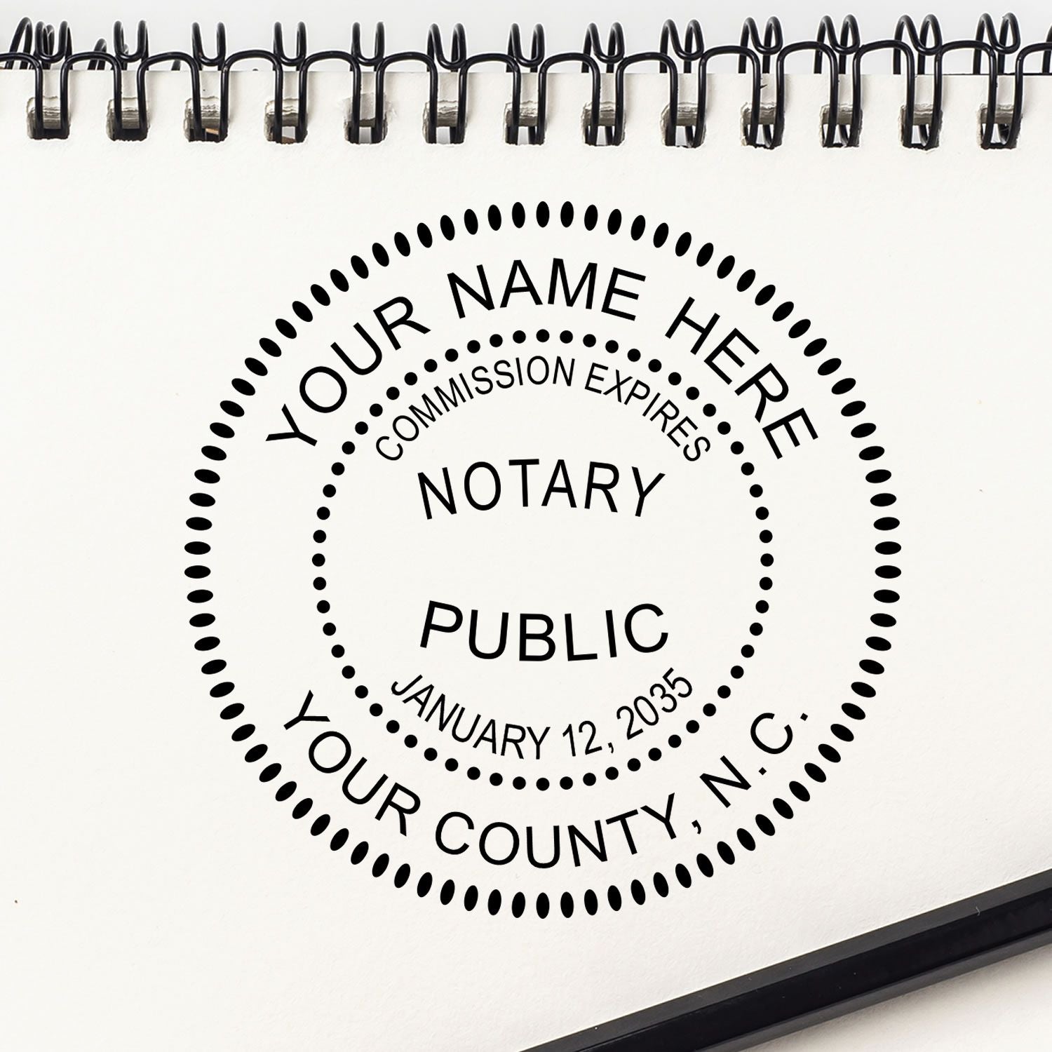 An alternative view of the Premium Pre-Inked North Carolina MaxLight Notary Public Stamp stamped on a sheet of paper showing the image in use