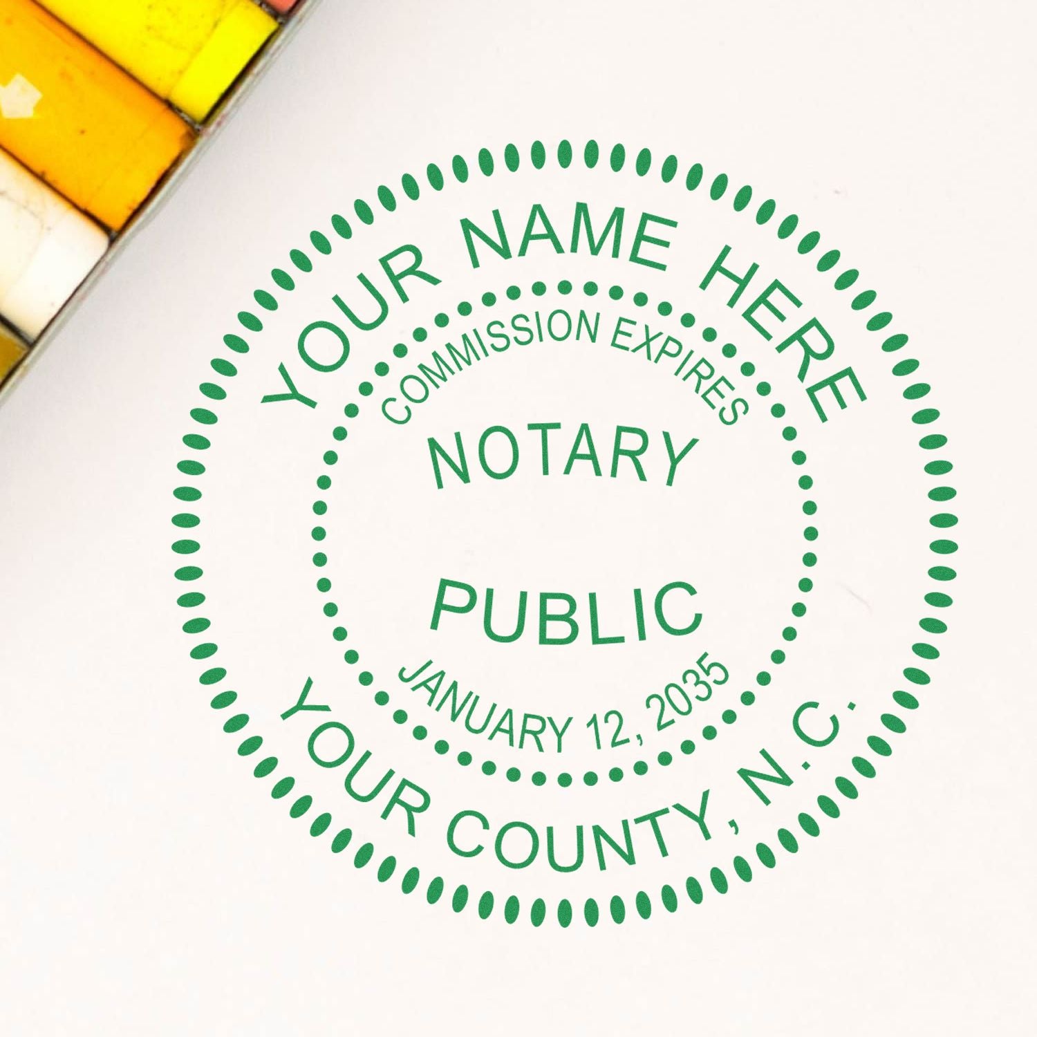 A lifestyle photo showing a stamped image of the Premium Pre-Inked North Carolina MaxLight Notary Public Stamp on a piece of paper