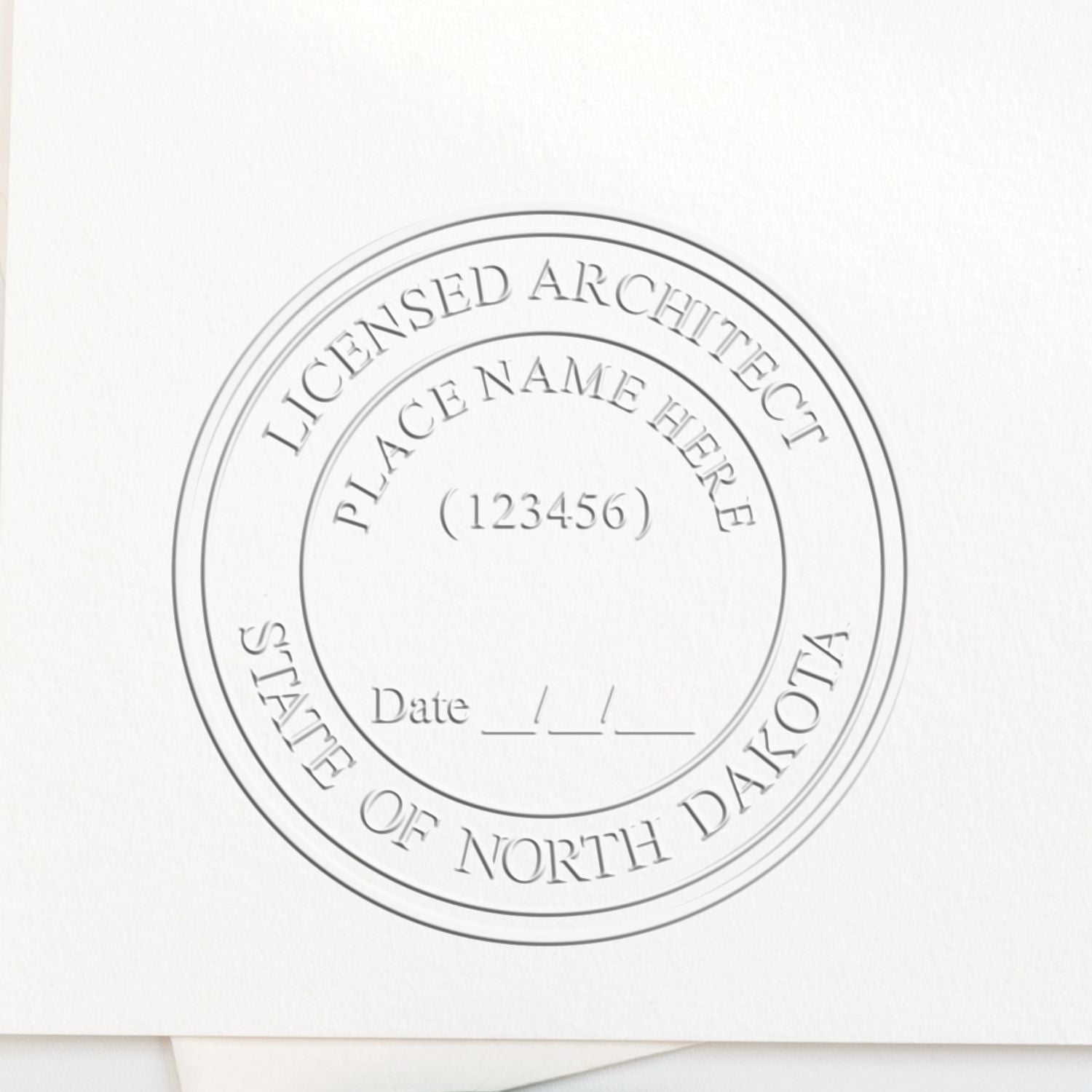 The main image for the Handheld North Dakota Architect Seal Embosser depicting a sample of the imprint and electronic files