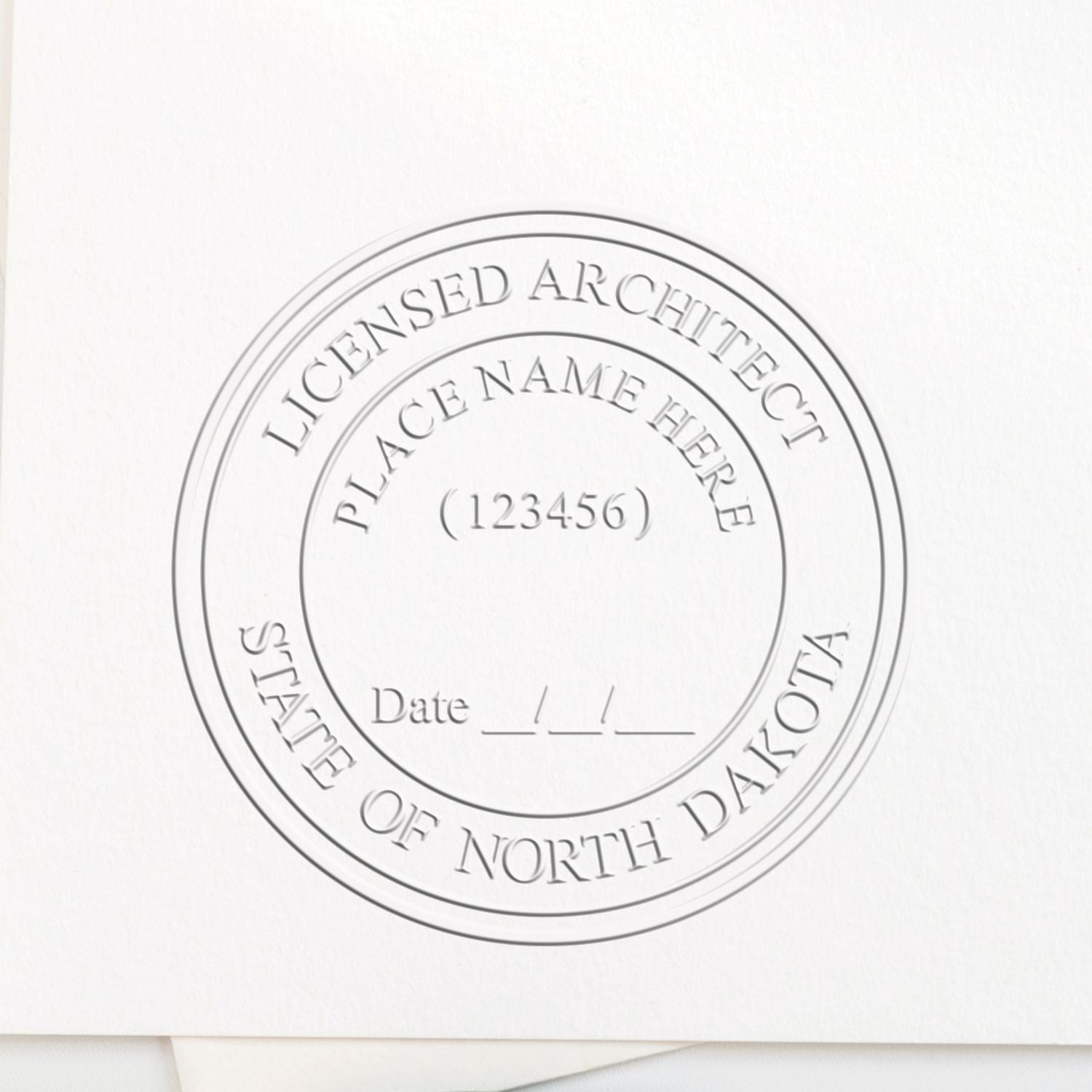 A stamped impression of the North Dakota Desk Architect Embossing Seal in this stylish lifestyle photo, setting the tone for a unique and personalized product.