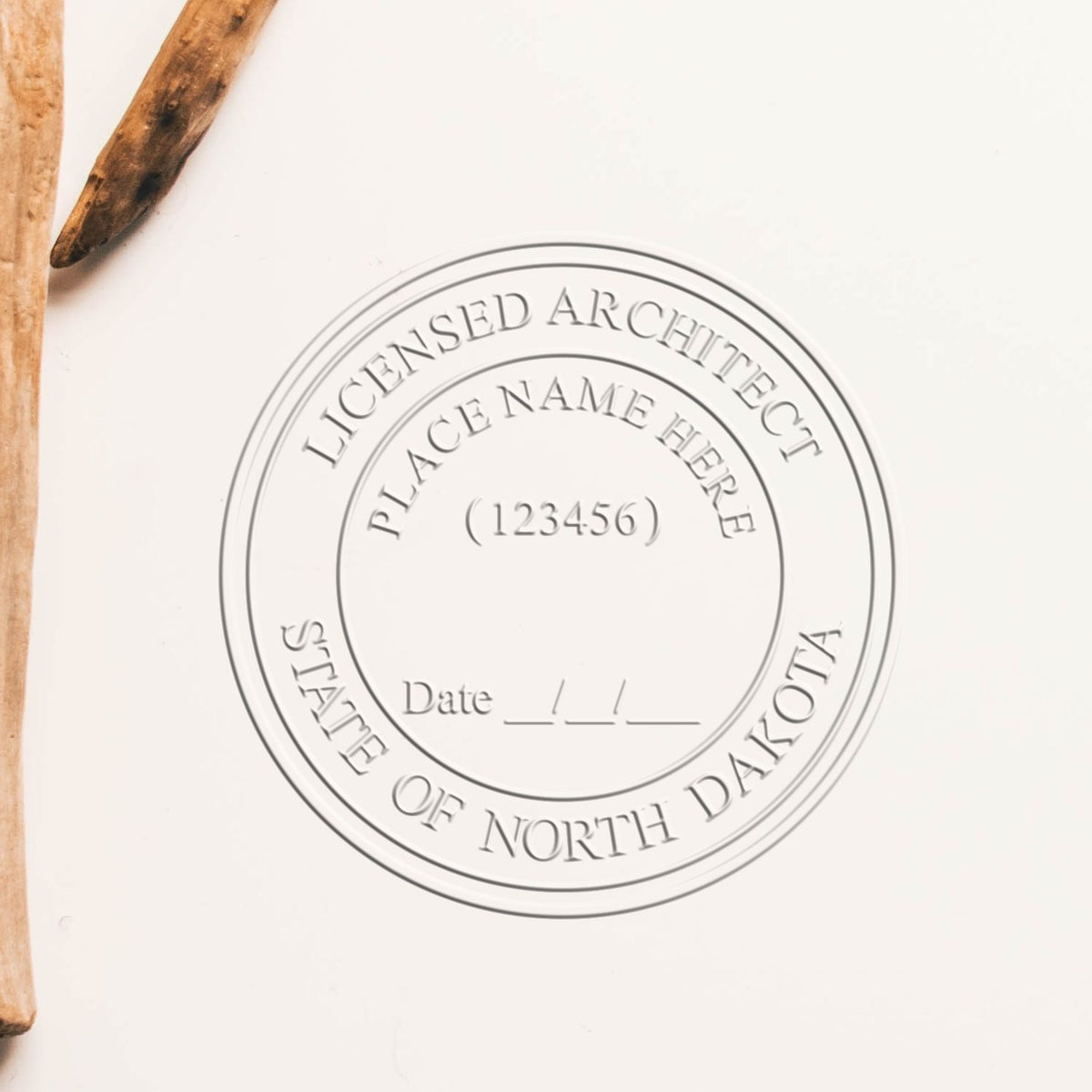 A stamped impression of the Handheld North Dakota Architect Seal Embosser in this stylish lifestyle photo, setting the tone for a unique and personalized product.