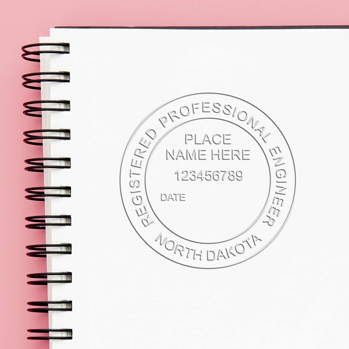 An in use photo of the Hybrid North Dakota Engineer Seal showing a sample imprint on a cardstock