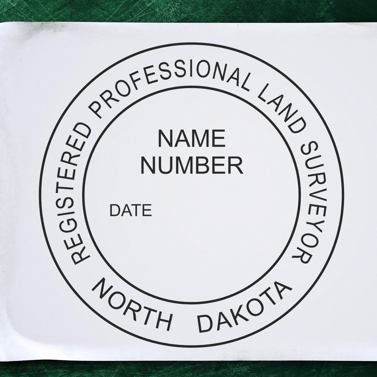 A lifestyle photo showing a stamped image of the Slim Pre-Inked North Dakota Land Surveyor Seal Stamp on a piece of paper