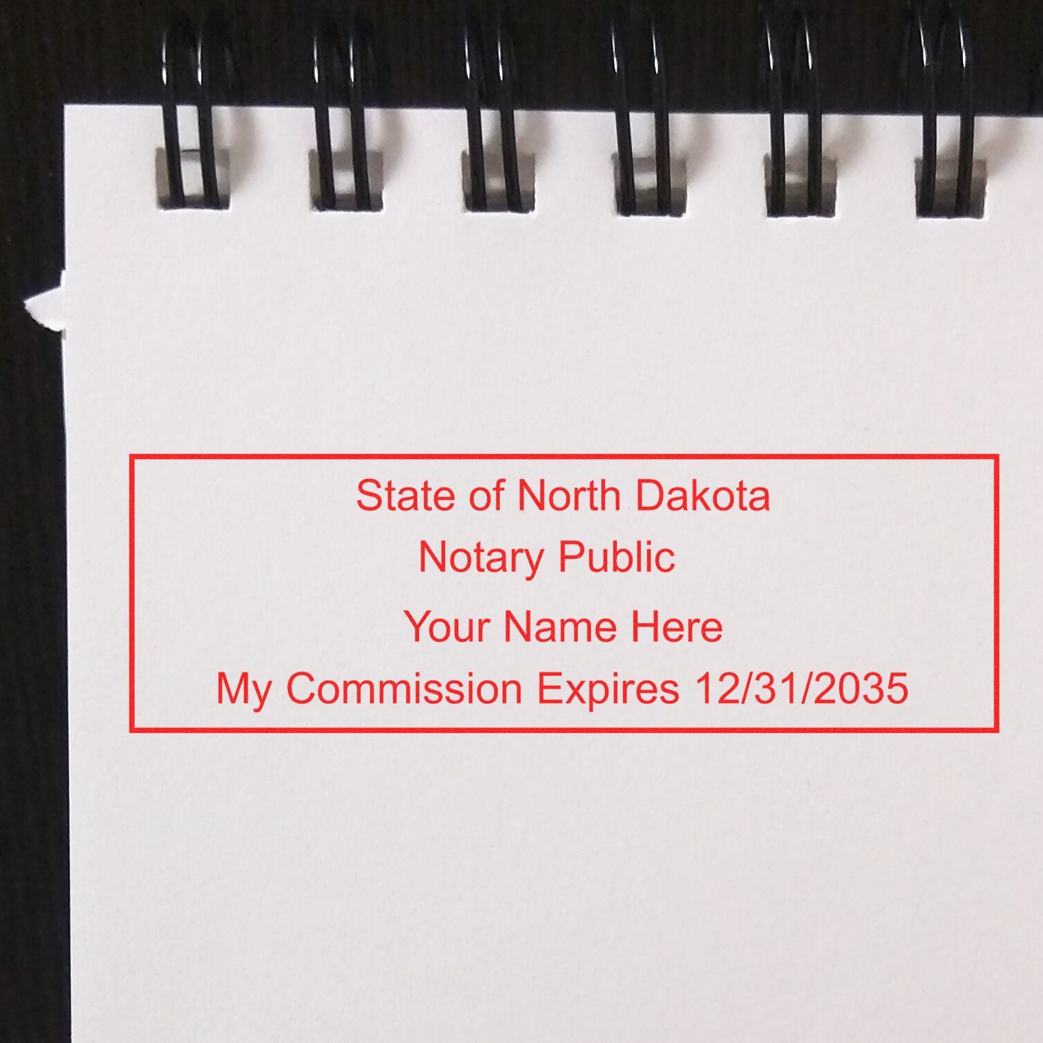 A photograph of the North Dakota Rectangular Digital Notary Seal stamp impression reveals a vivid, professional image of the on paper.