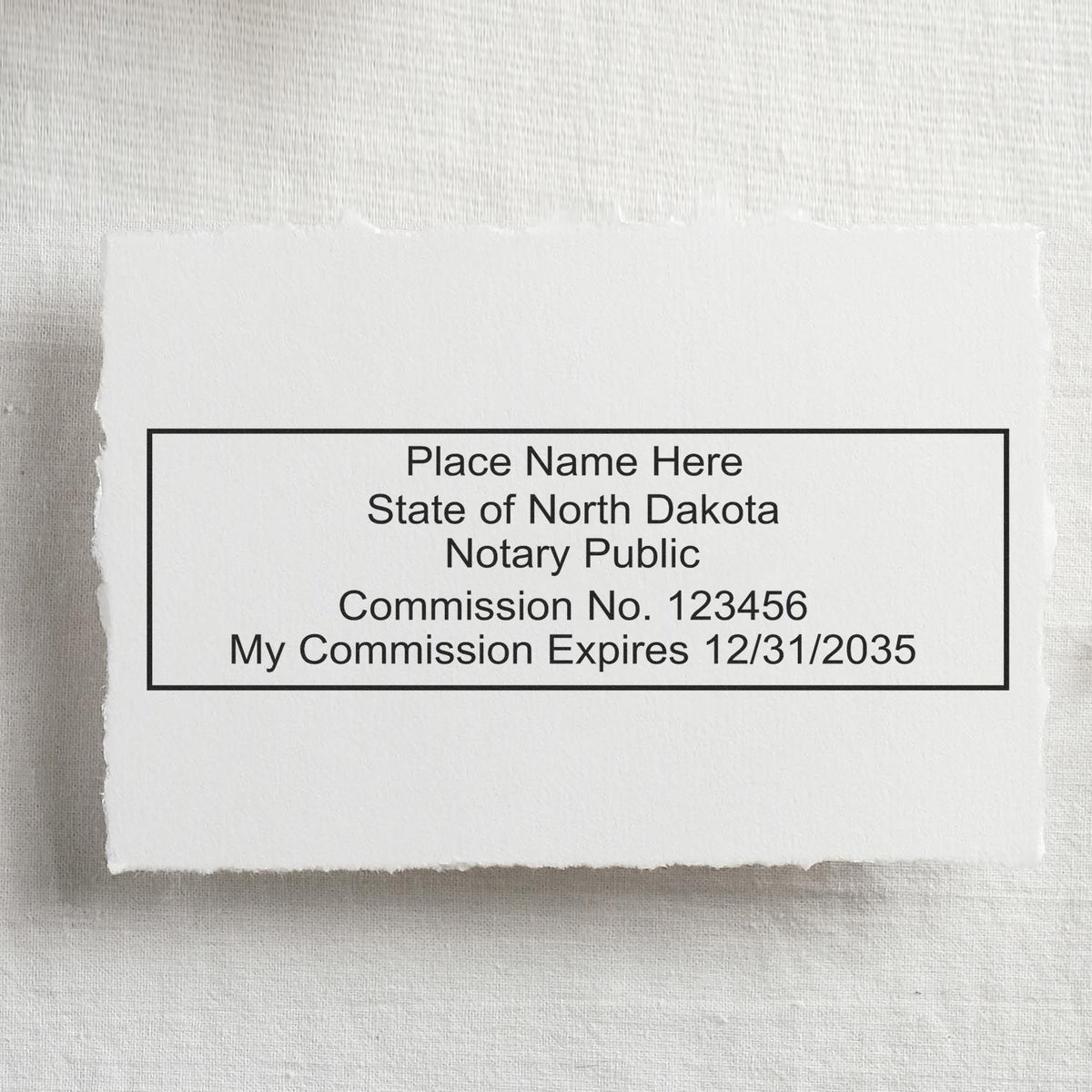 A lifestyle photo showing a stamped image of the MaxLight Premium Pre-Inked North Dakota Rectangular Notarial Stamp on a piece of paper