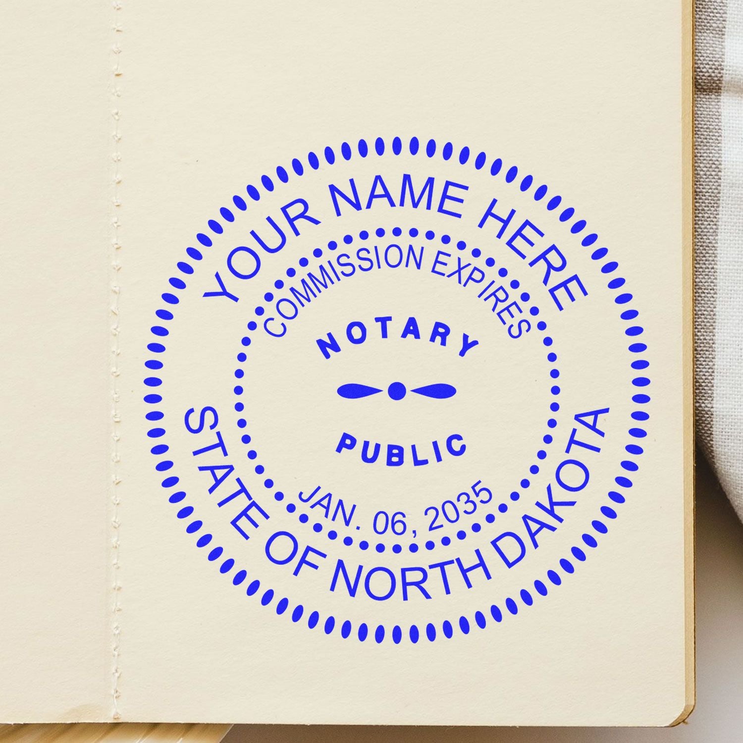 This paper is stamped with a sample imprint of the Round North Dakota Notary Public Seal Stamp, signifying its quality and reliability.