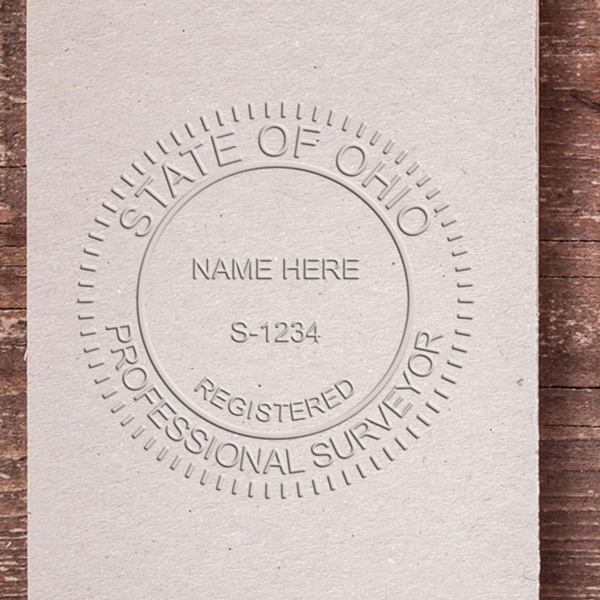 A photograph of the Hybrid Ohio Land Surveyor Seal stamp impression reveals a vivid, professional image of the on paper.