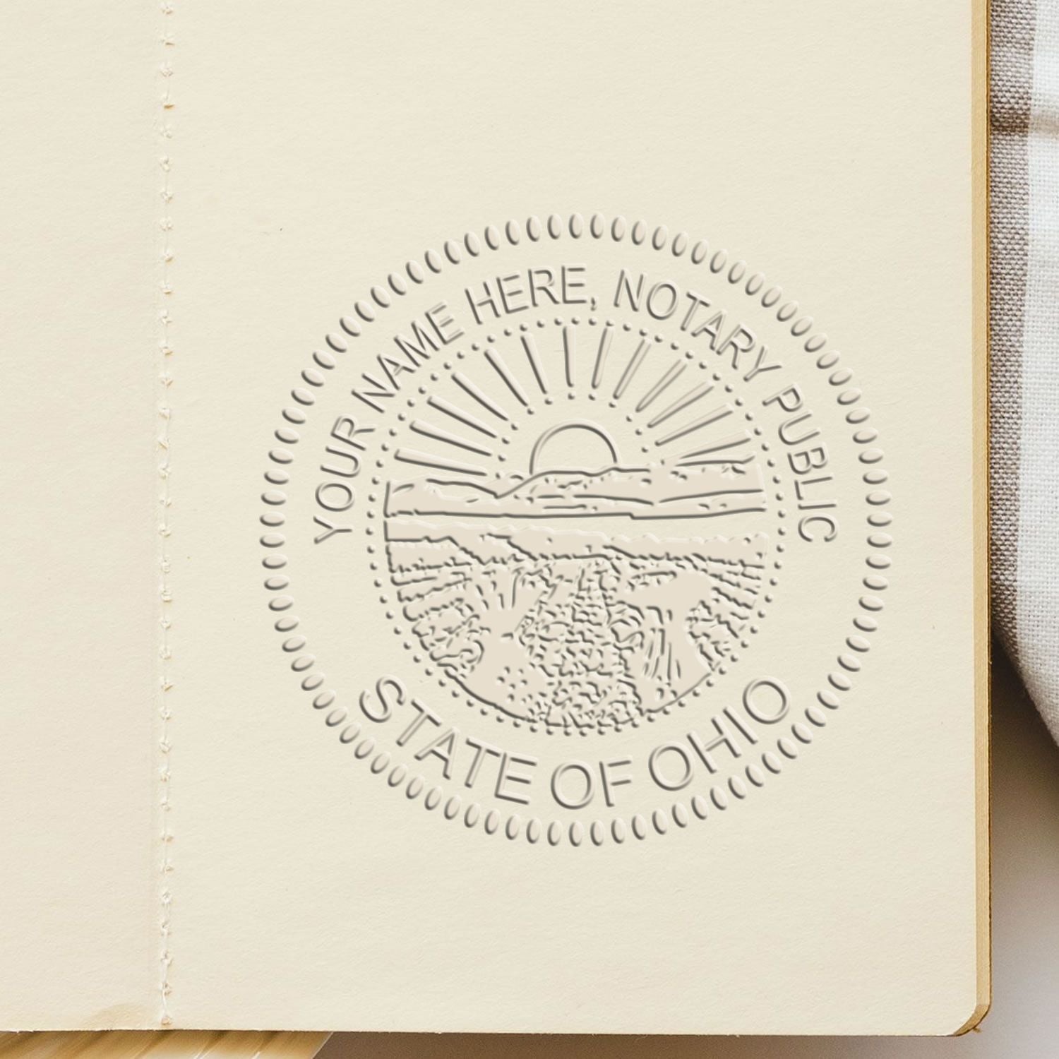 The Ohio Handheld Notary Seal Embosser stamp impression comes to life with a crisp, detailed photo on paper - showcasing true professional quality.